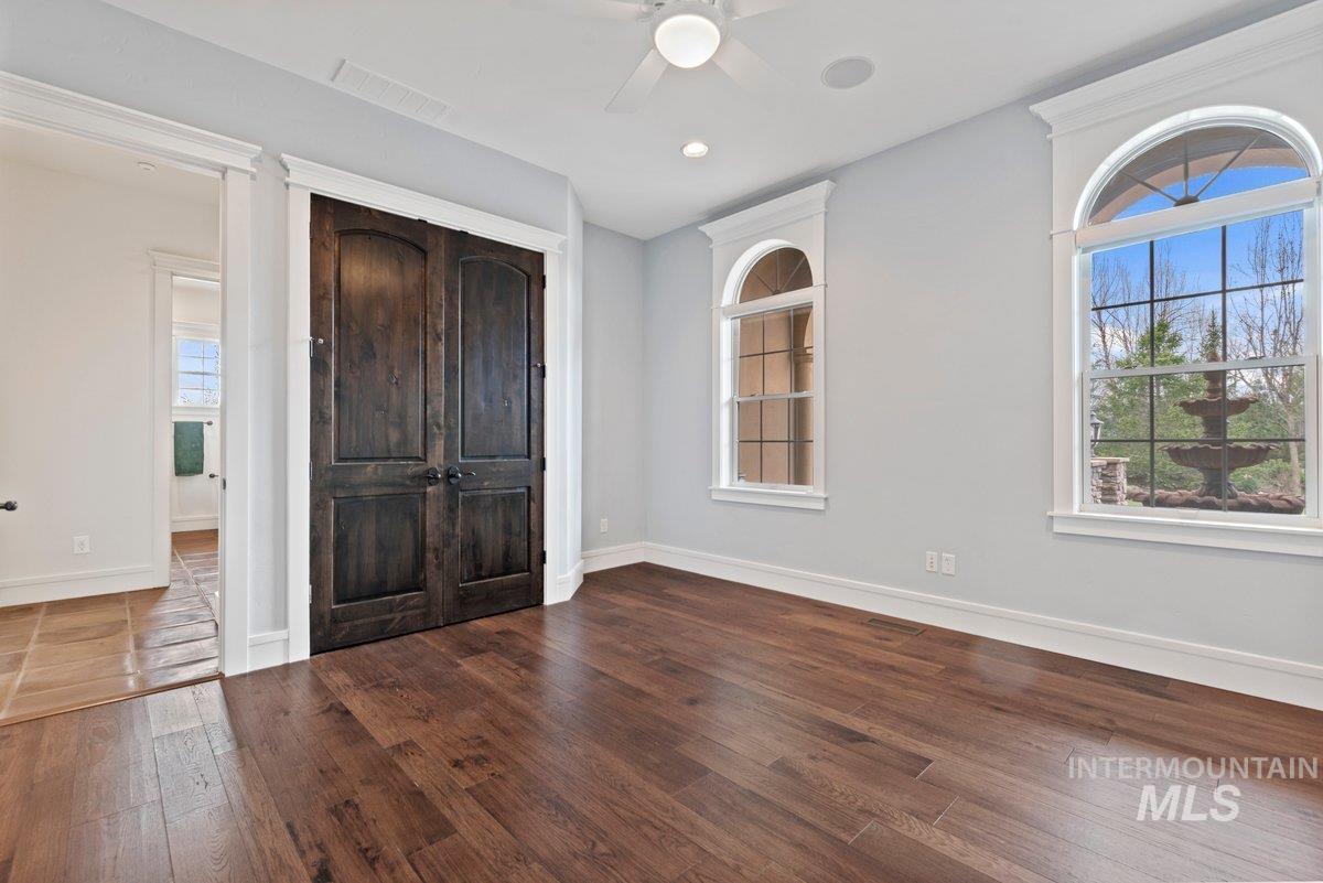 Unfurnished bedroom featuring a closet, hardwood / wood-style flooring, ceiling fan, and recessed lighting