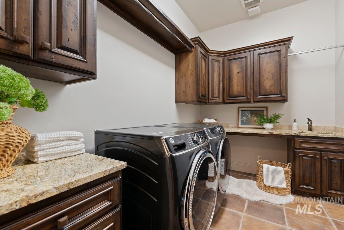 Laundry area with cabinet space and washing machine and clothes dryer