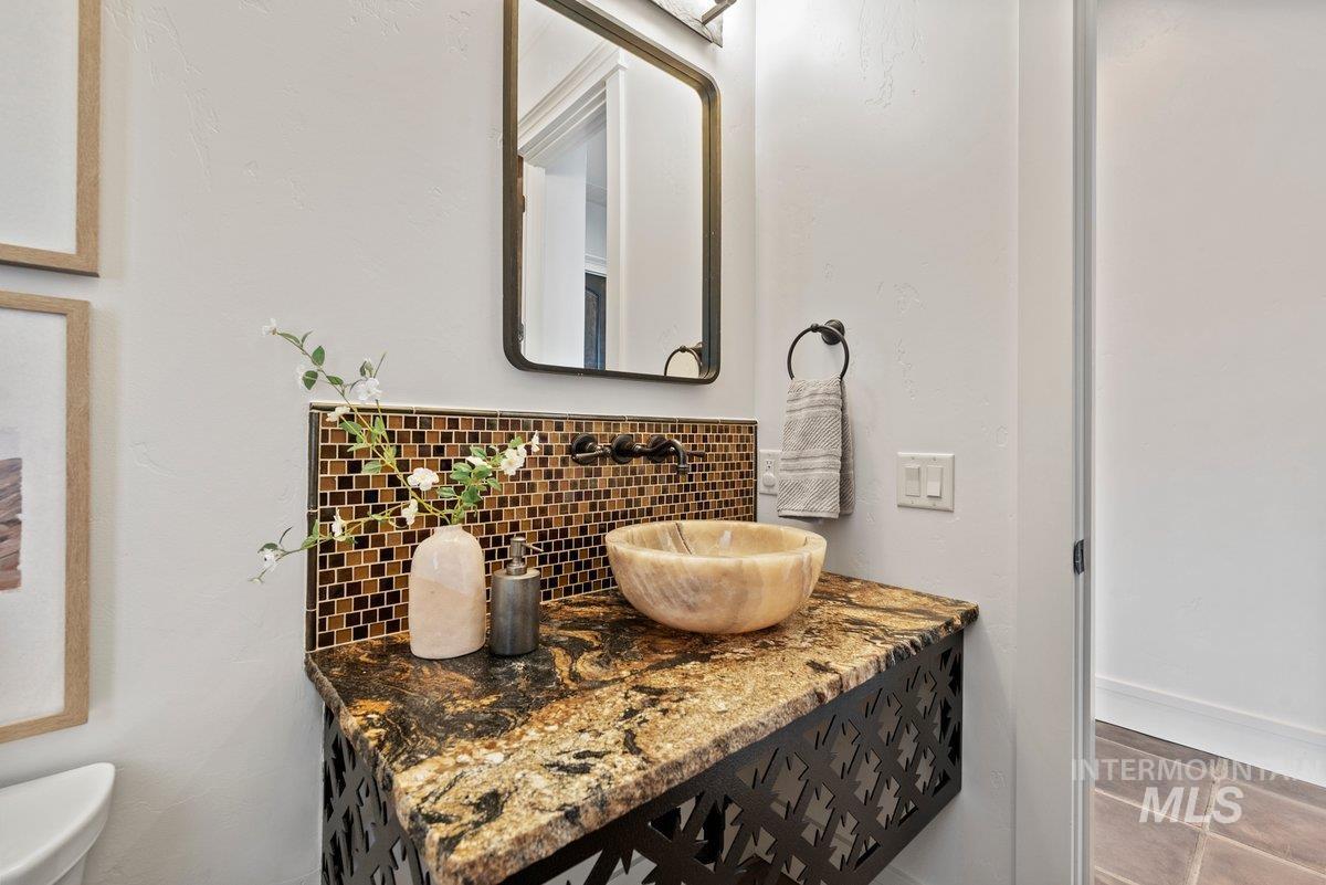 Bathroom featuring decorative backsplash and vanity