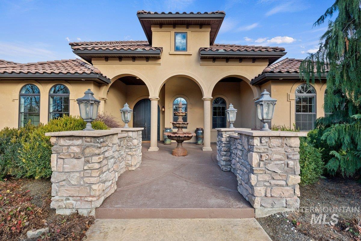 View of front of property featuring stucco siding and a tile roof