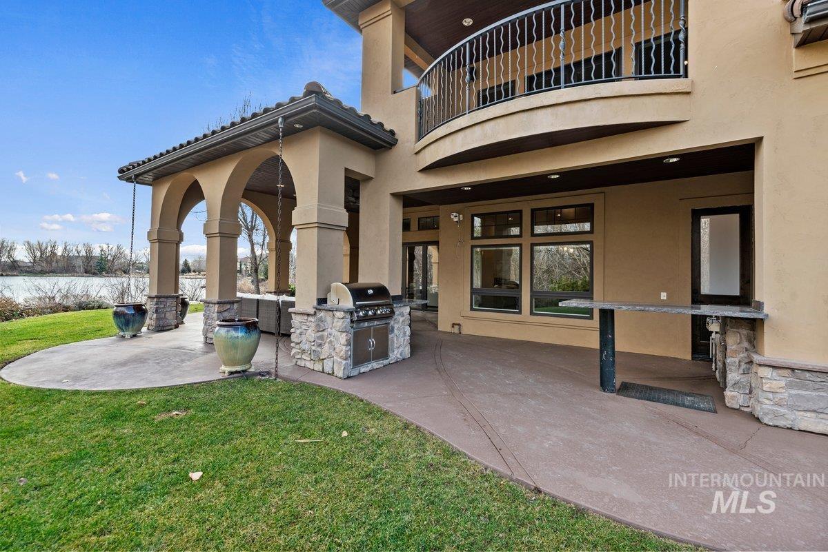 Patio / terrace with a patio area, exterior kitchen, and a lawn