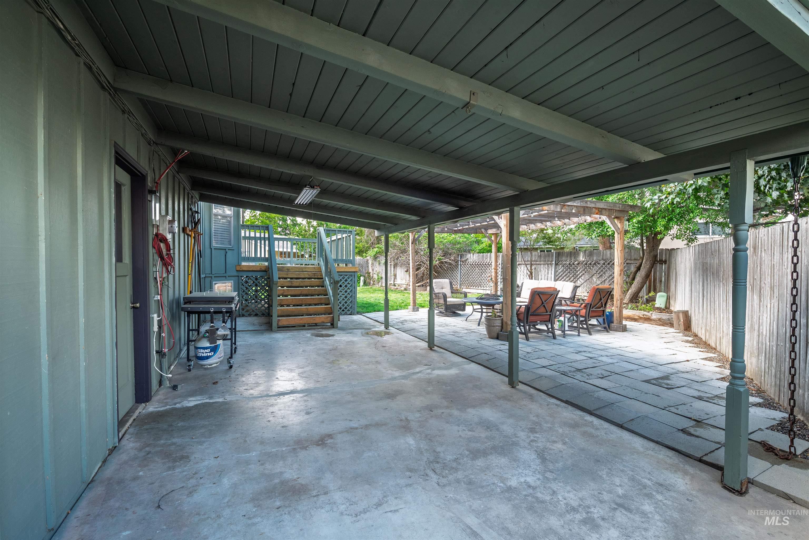 Fenced backyard featuring stairs and a patio area