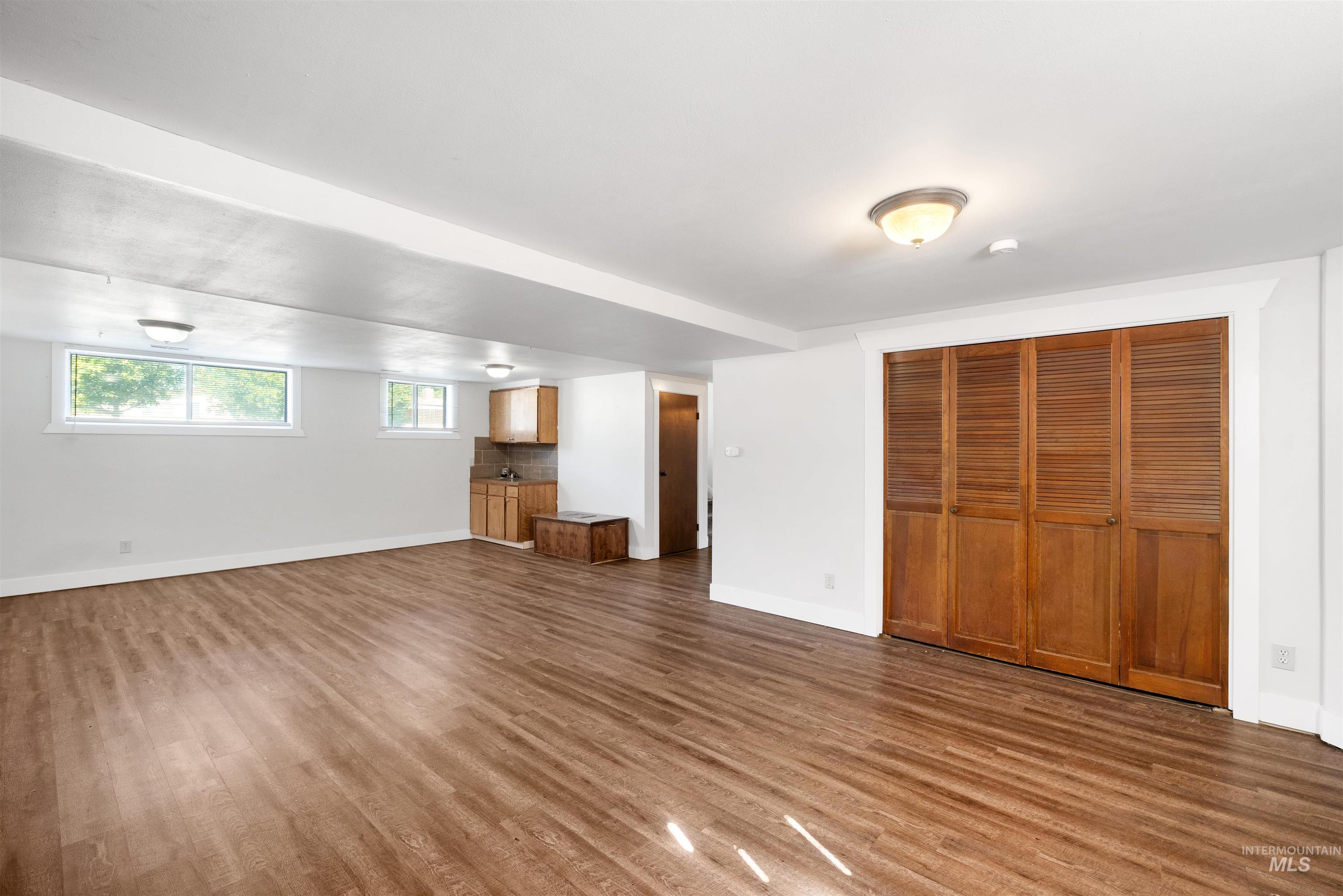 Unfurnished living room featuring wood finished floors