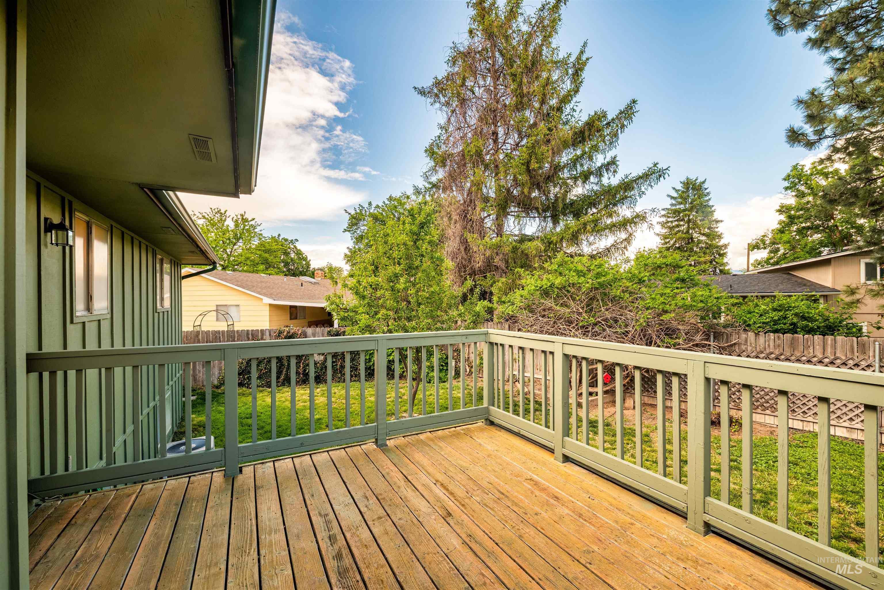 Wooden terrace featuring a fenced backyard