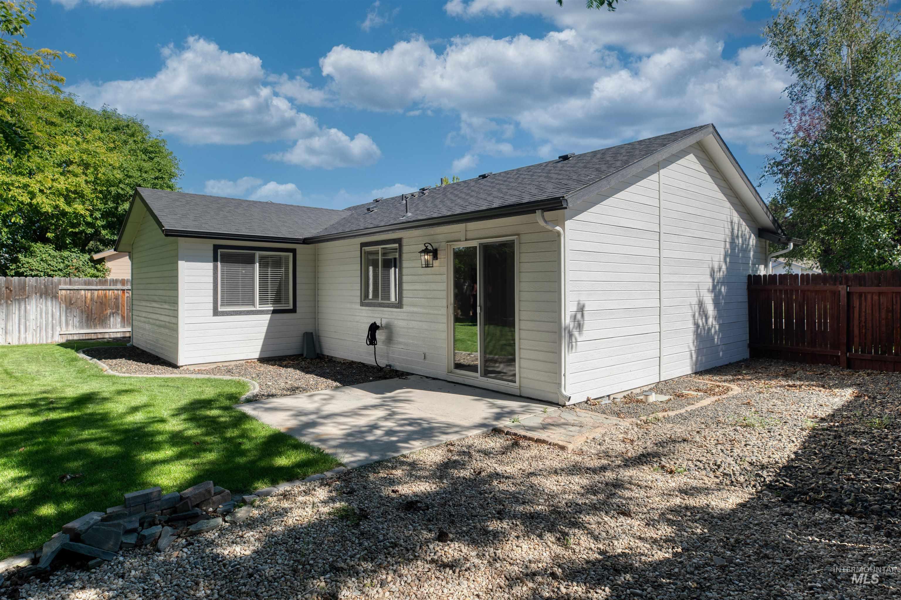 White-paneled exterior with dark trim and a dark shingle roof