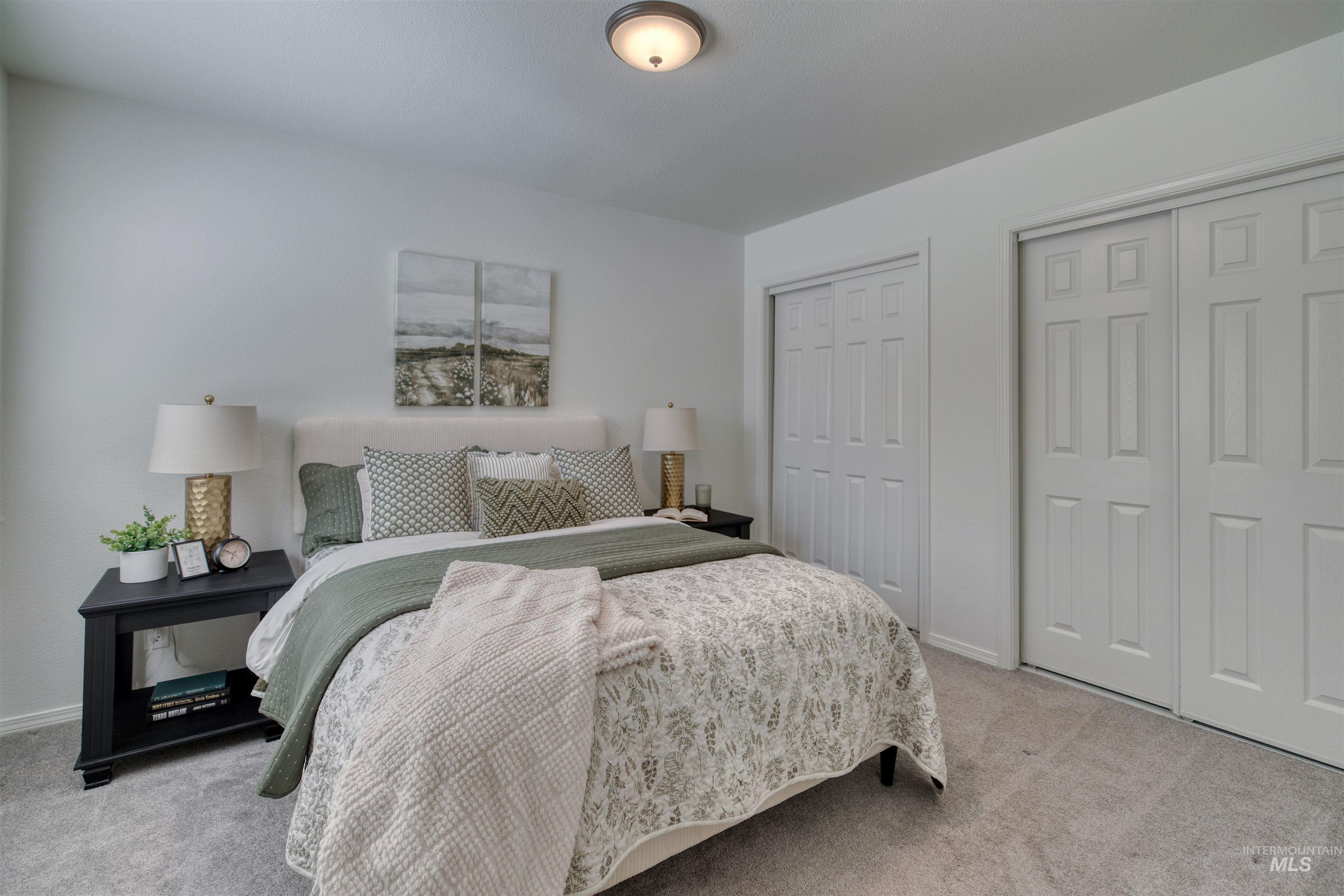 Light-colored carpeted flooring with a contrasting white upholstered headboard