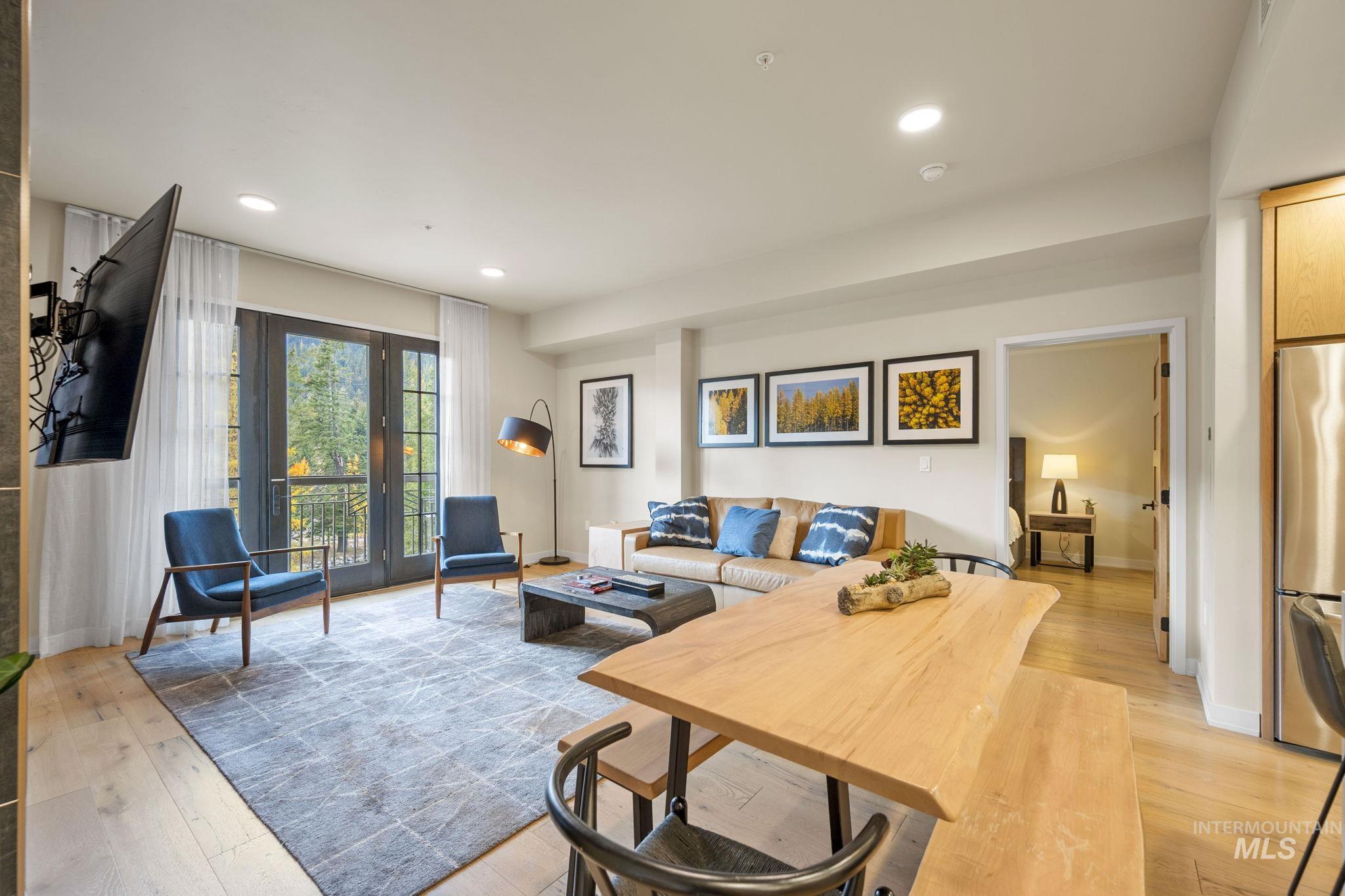 Living area with recessed lighting and light wood finished floors