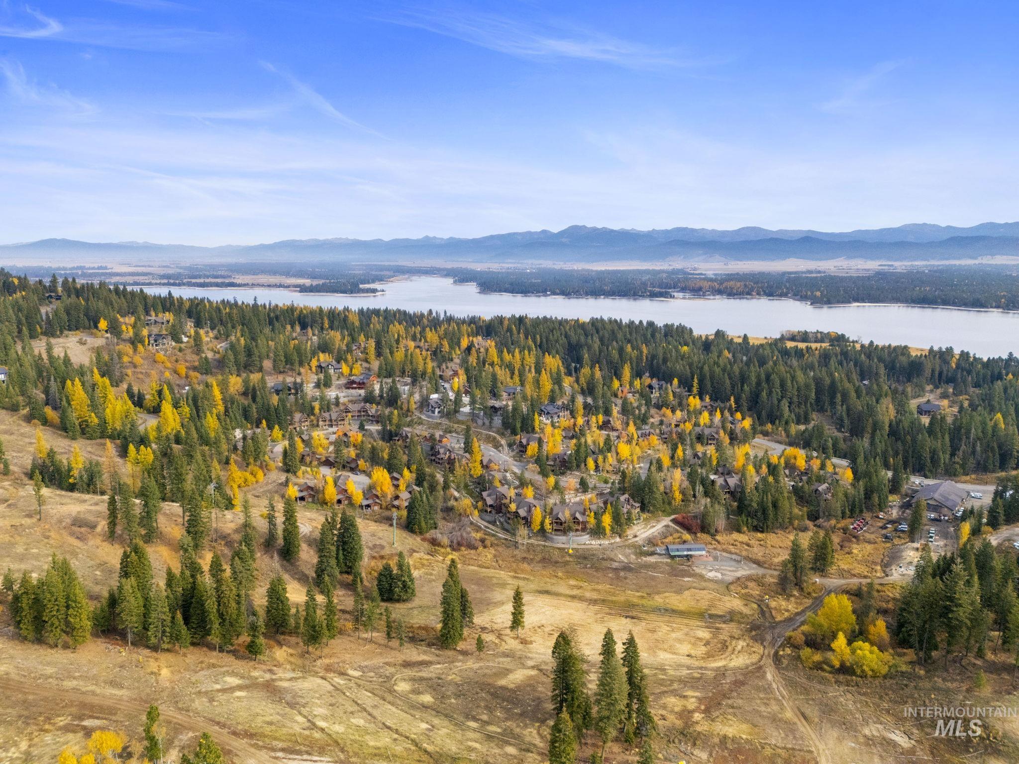 Aerial view of property and surrounding area featuring a water and mountain view