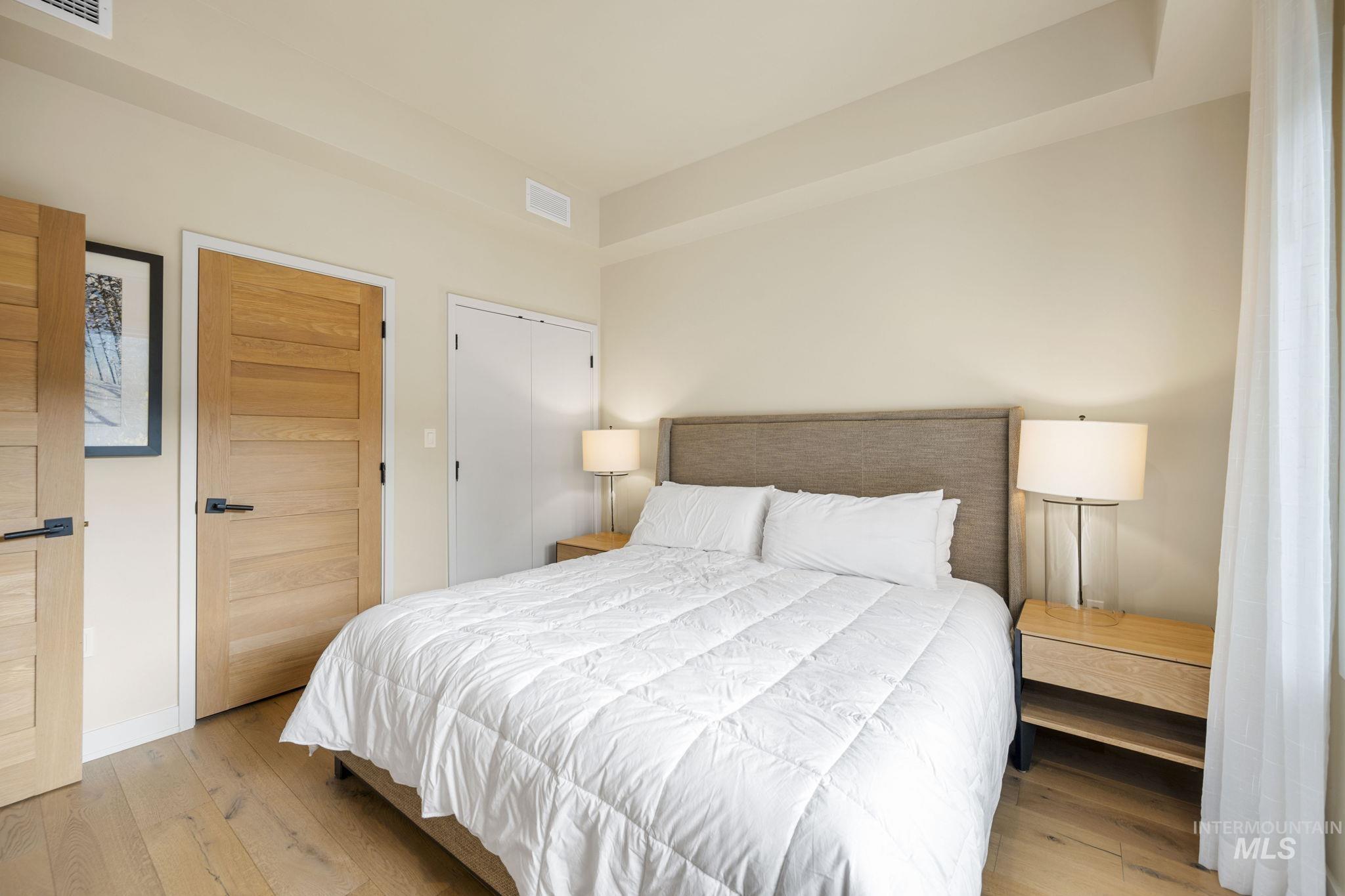 Bedroom with hardwood / wood-style flooring and a closet