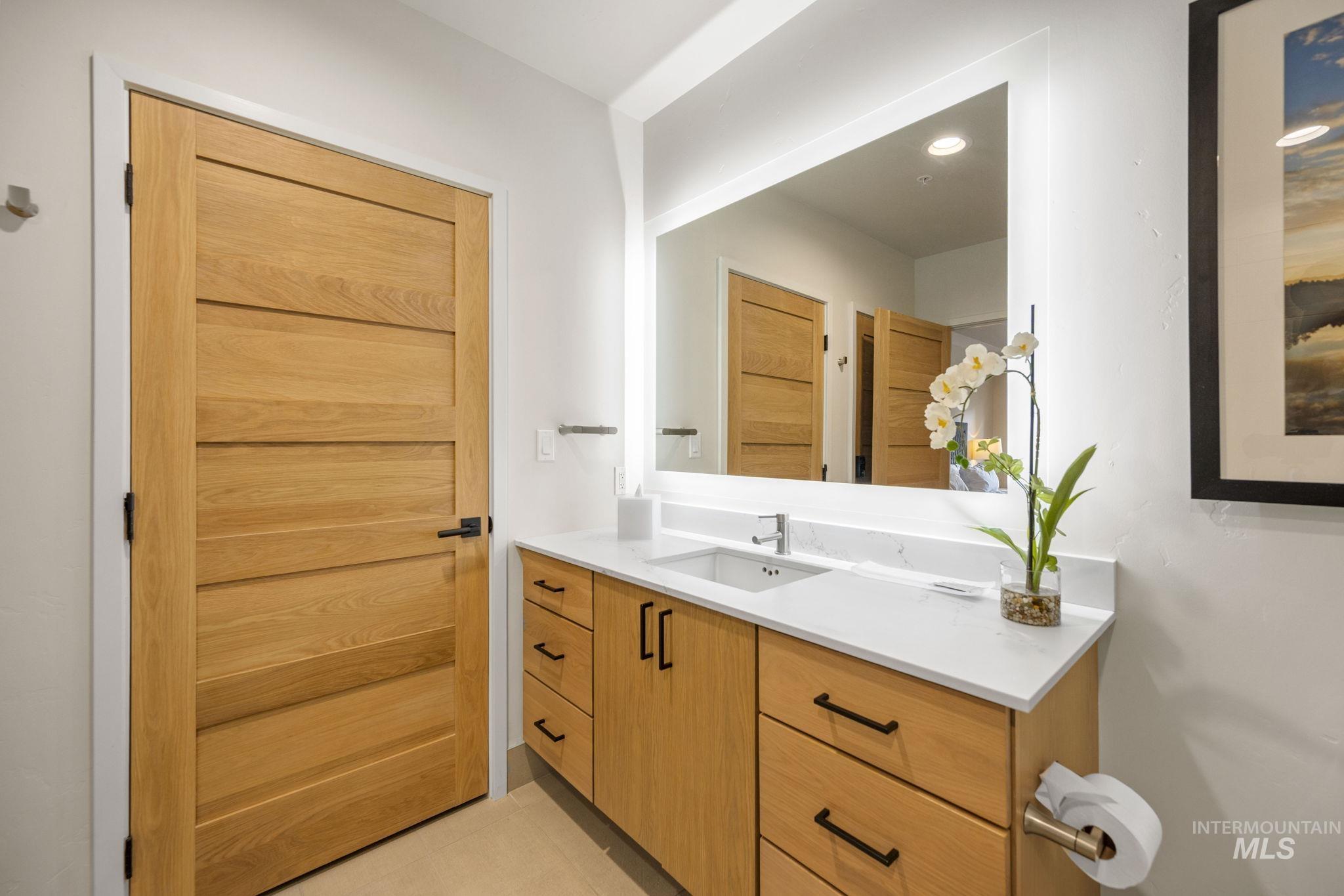 Bathroom with vanity and light tile patterned floors