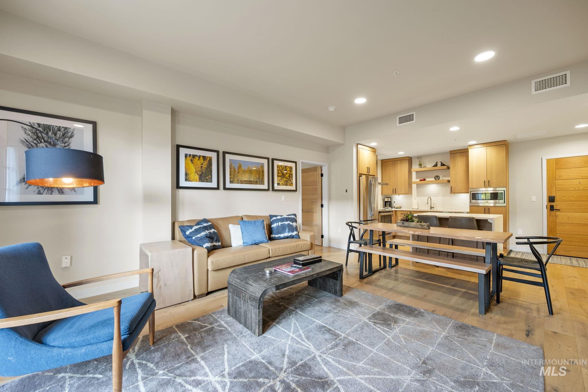 Living room featuring light wood finished floors and recessed lighting