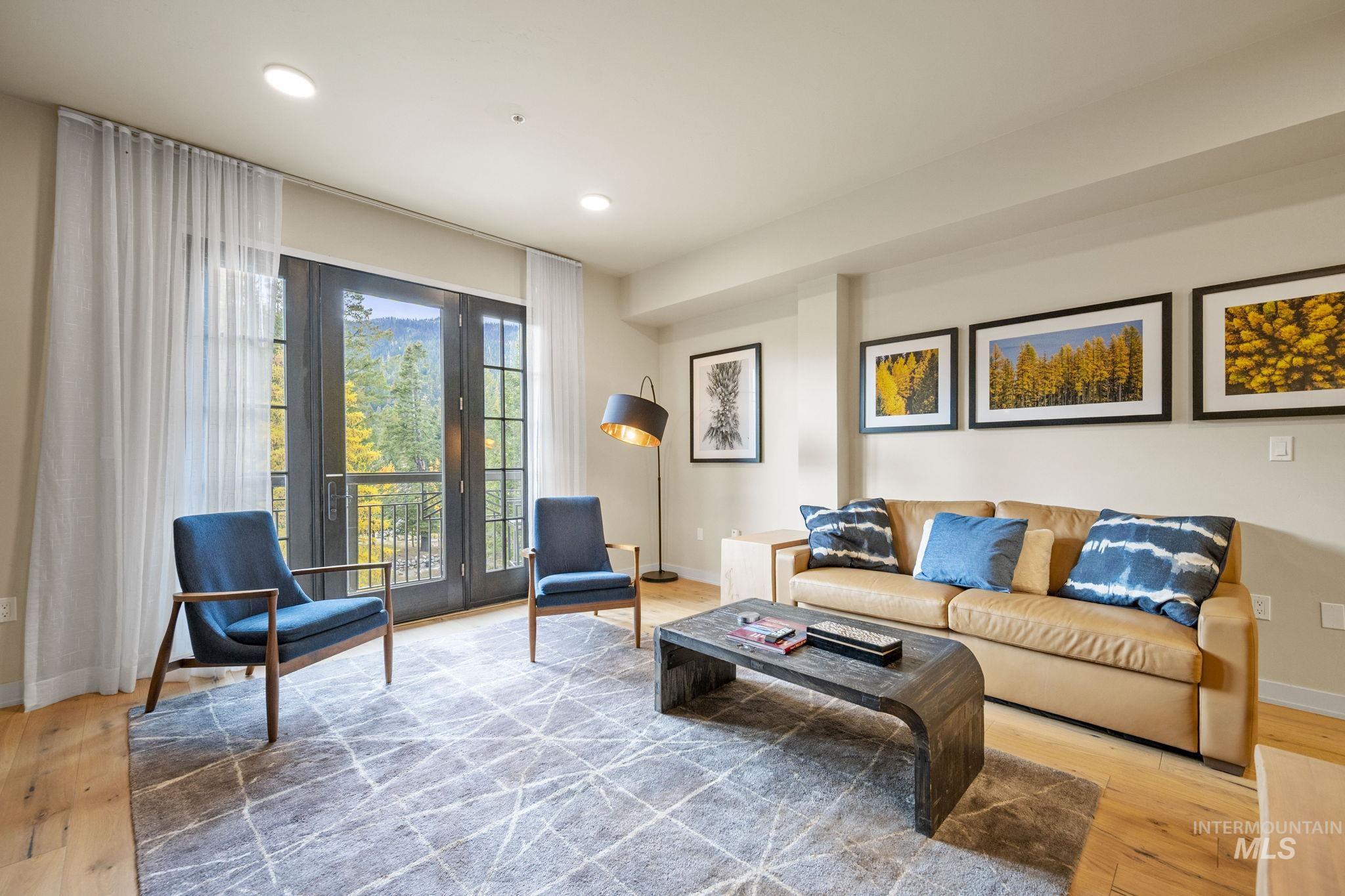 Living room with light wood-style floors and recessed lighting