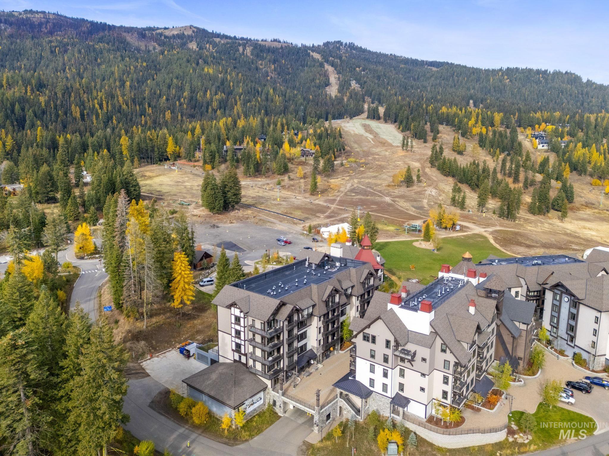 Bird's eye view of apartment complex and a forest