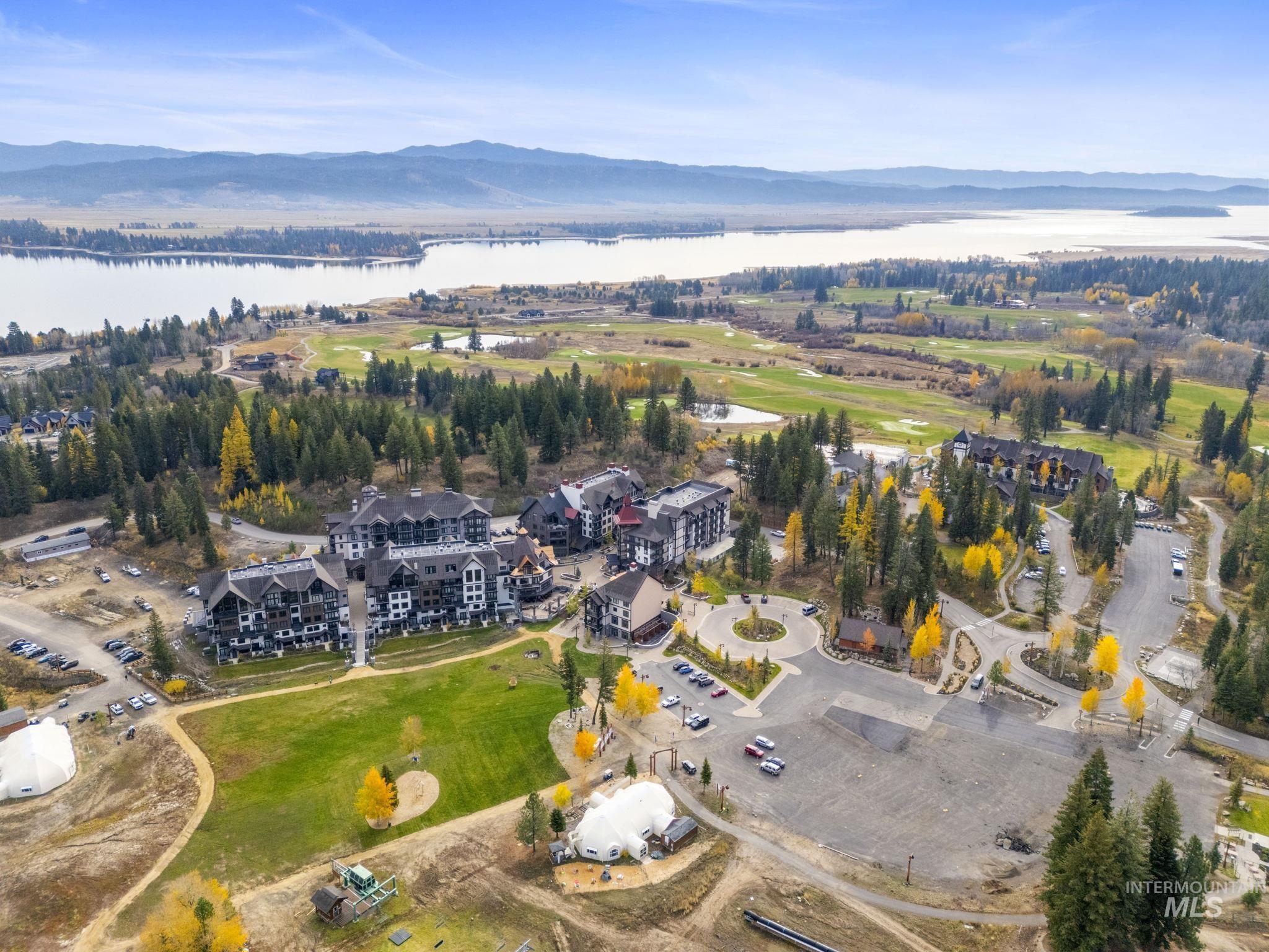 Aerial view of property and surrounding area with a water and mountain view