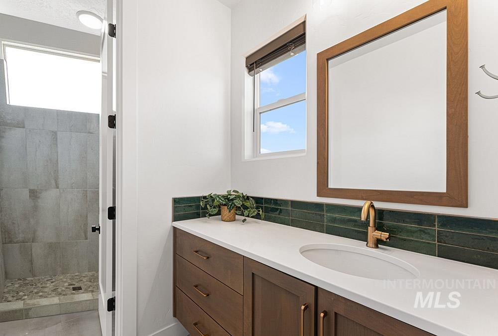 Bathroom featuring vanity and a tile shower