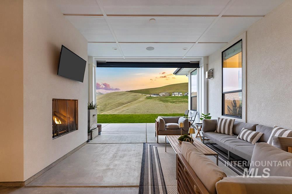 View of patio with an outdoor living space with a fireplace