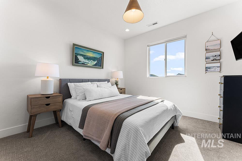Bedroom with carpet flooring and baseboards