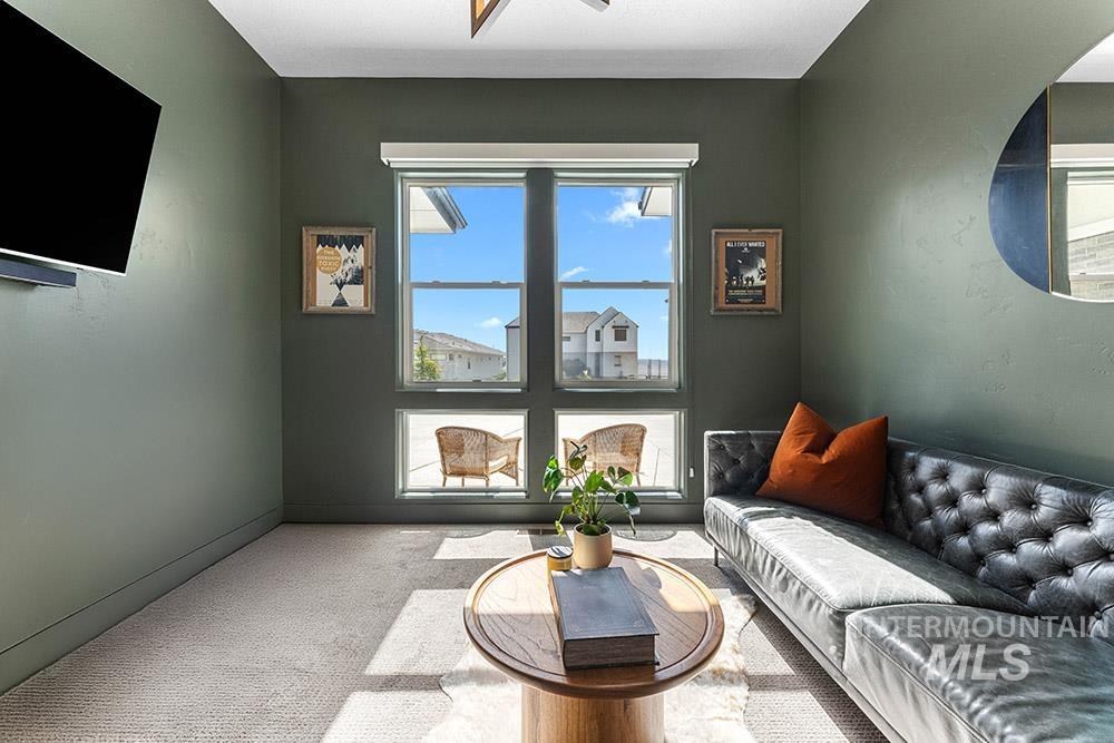 Living area with carpet floors and baseboards