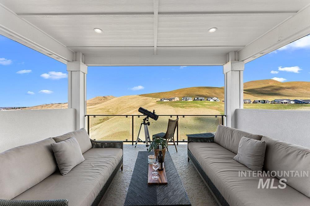 Patio / terrace with an outdoor hangout area and a mountain view