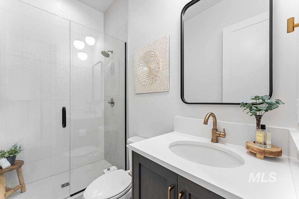 Full bath with vanity and a shower stall
