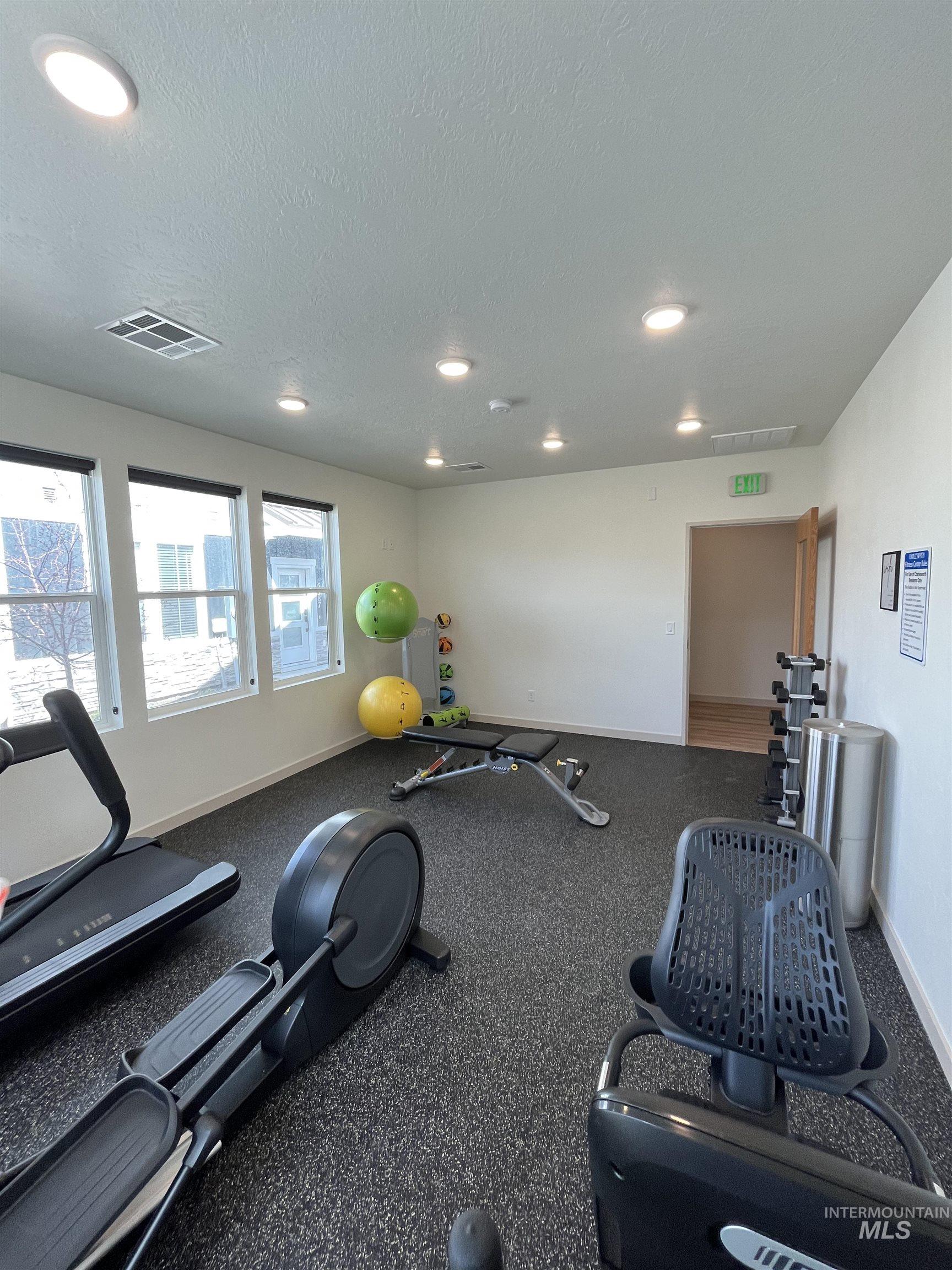 Workout area with recessed lighting and a textured ceiling