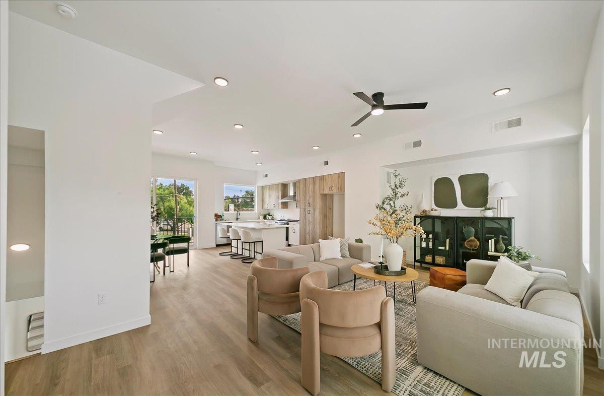 Living area featuring light wood-style floors, recessed lighting, and a ceiling fan