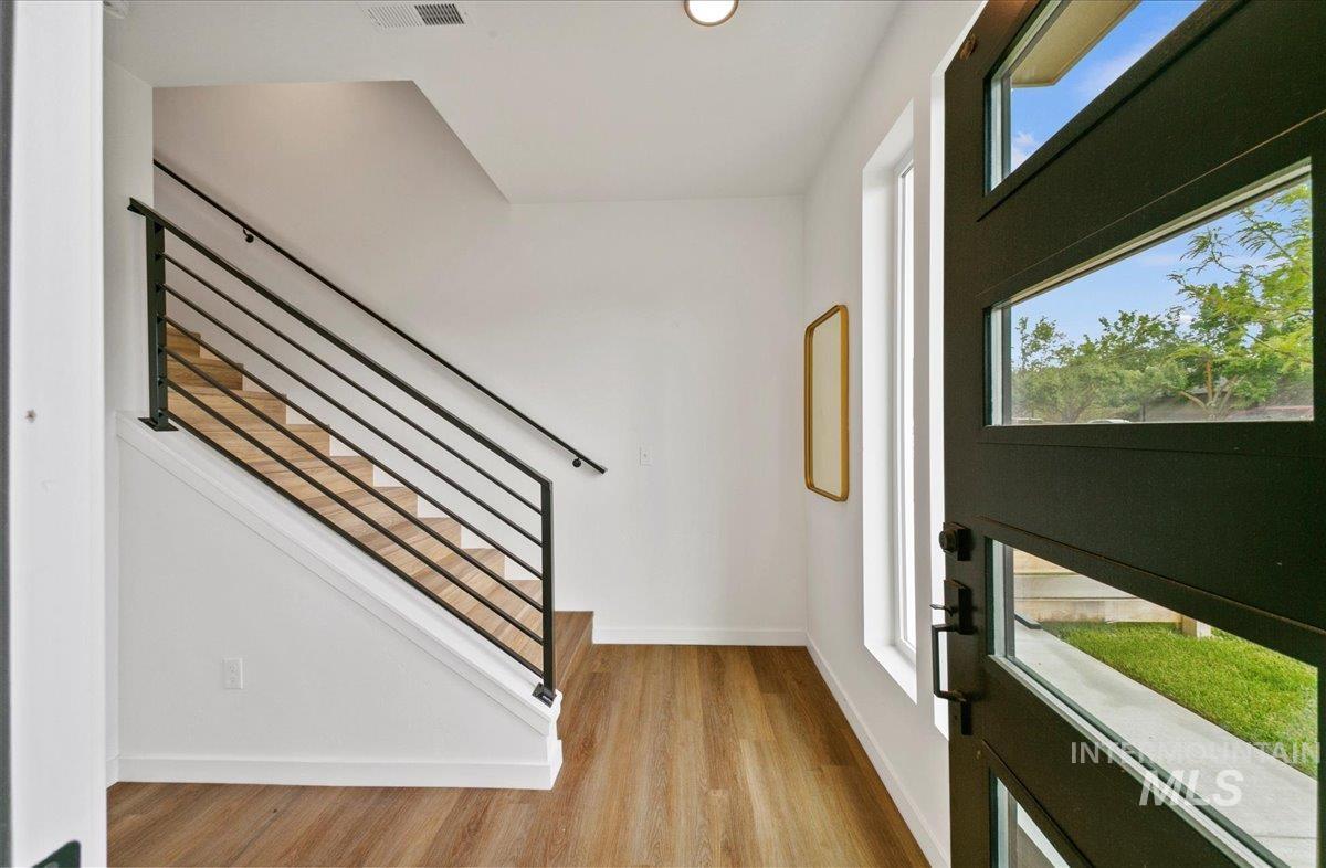 Entryway featuring light wood-style floors and recessed lighting