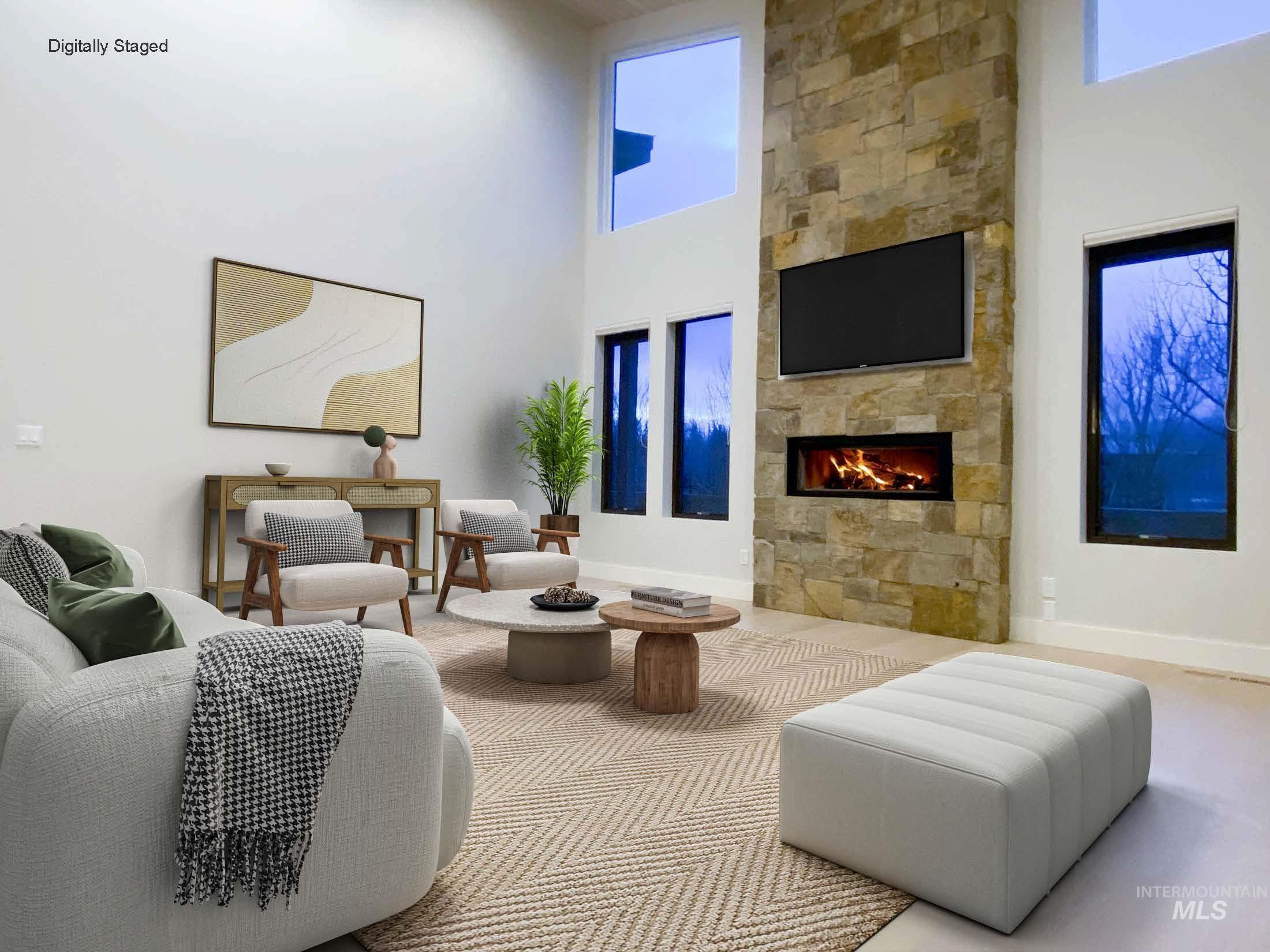 DIGITALLY STAGED - Living room with a towering ceiling and a large fireplace