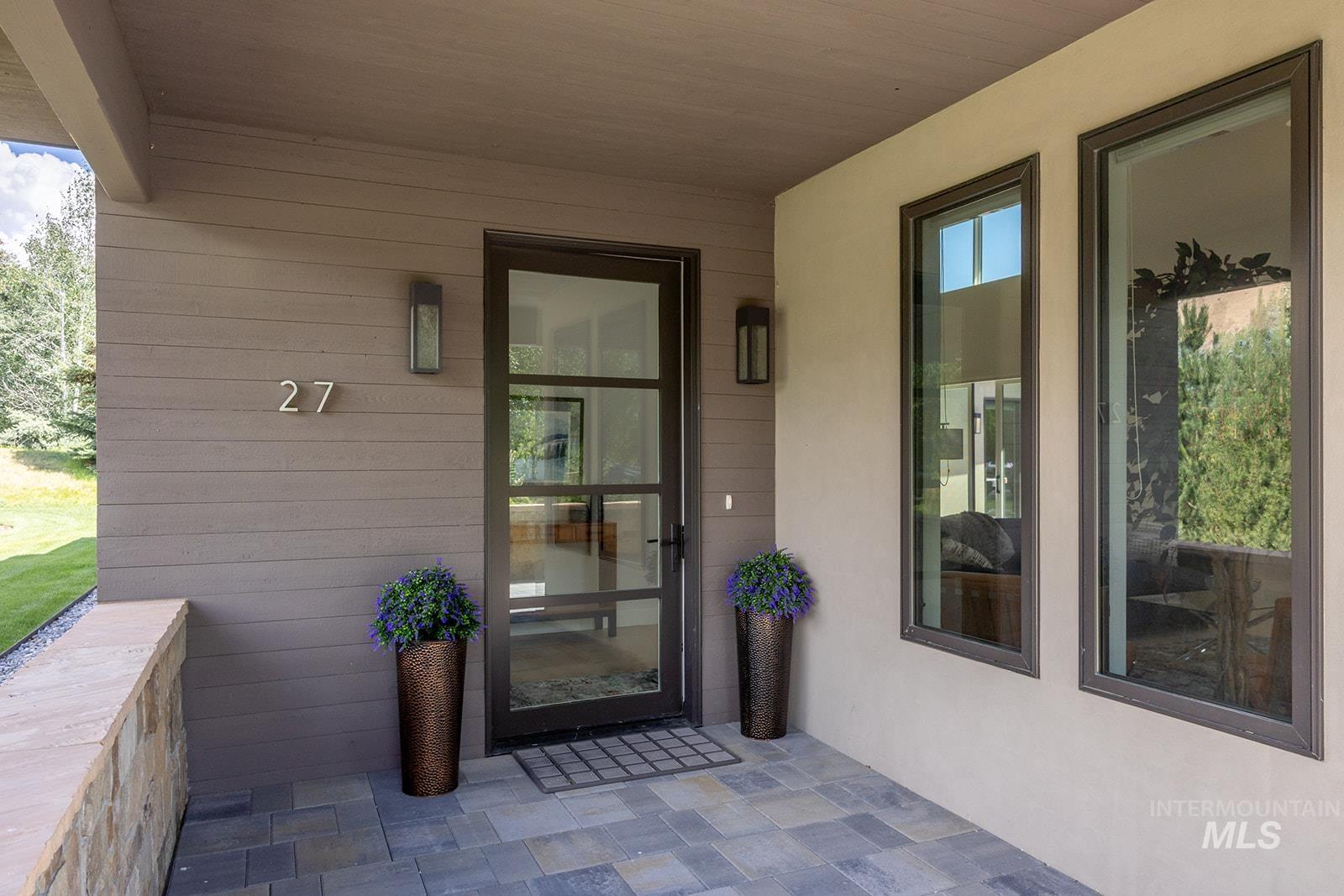 Entrance to property with stucco siding