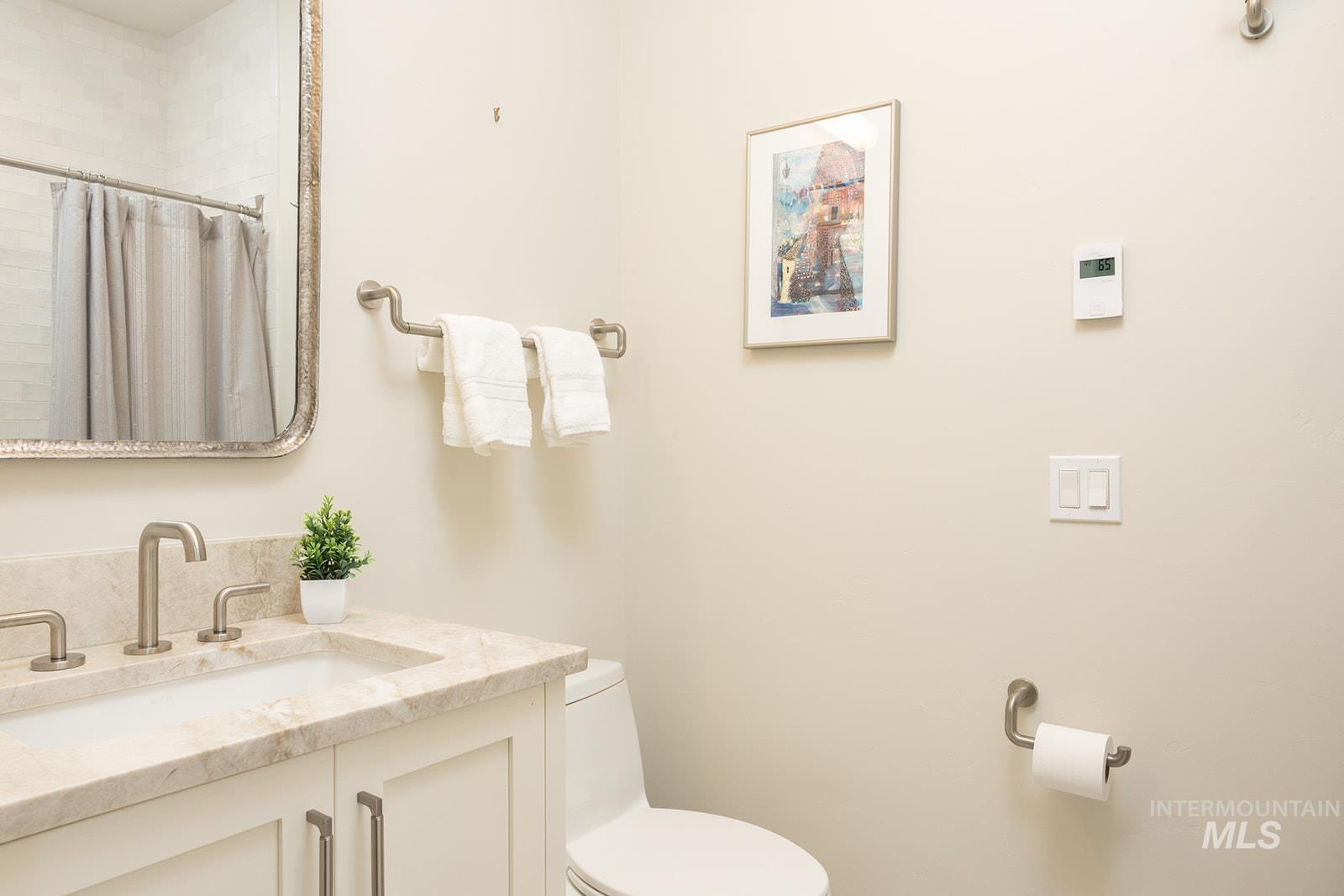 Full bath with vanity and a tile shower