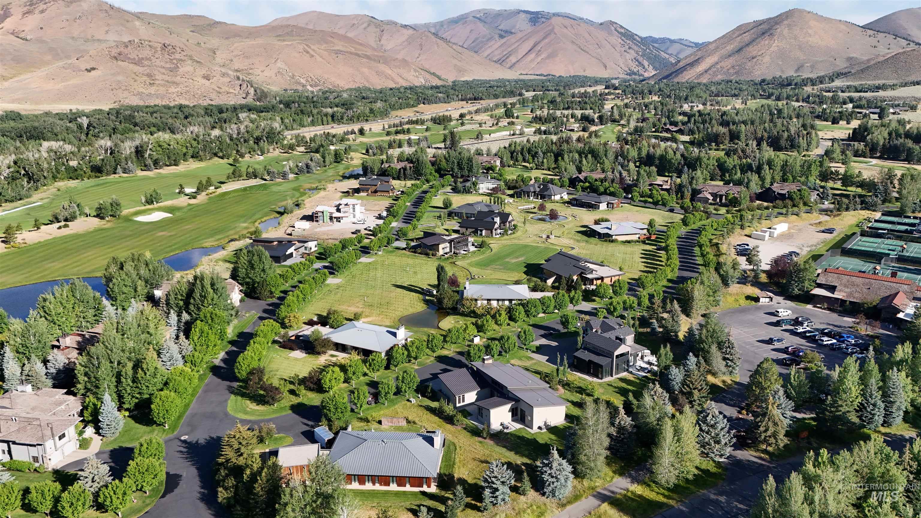 View of property location featuring a golf course and a water and mountain view