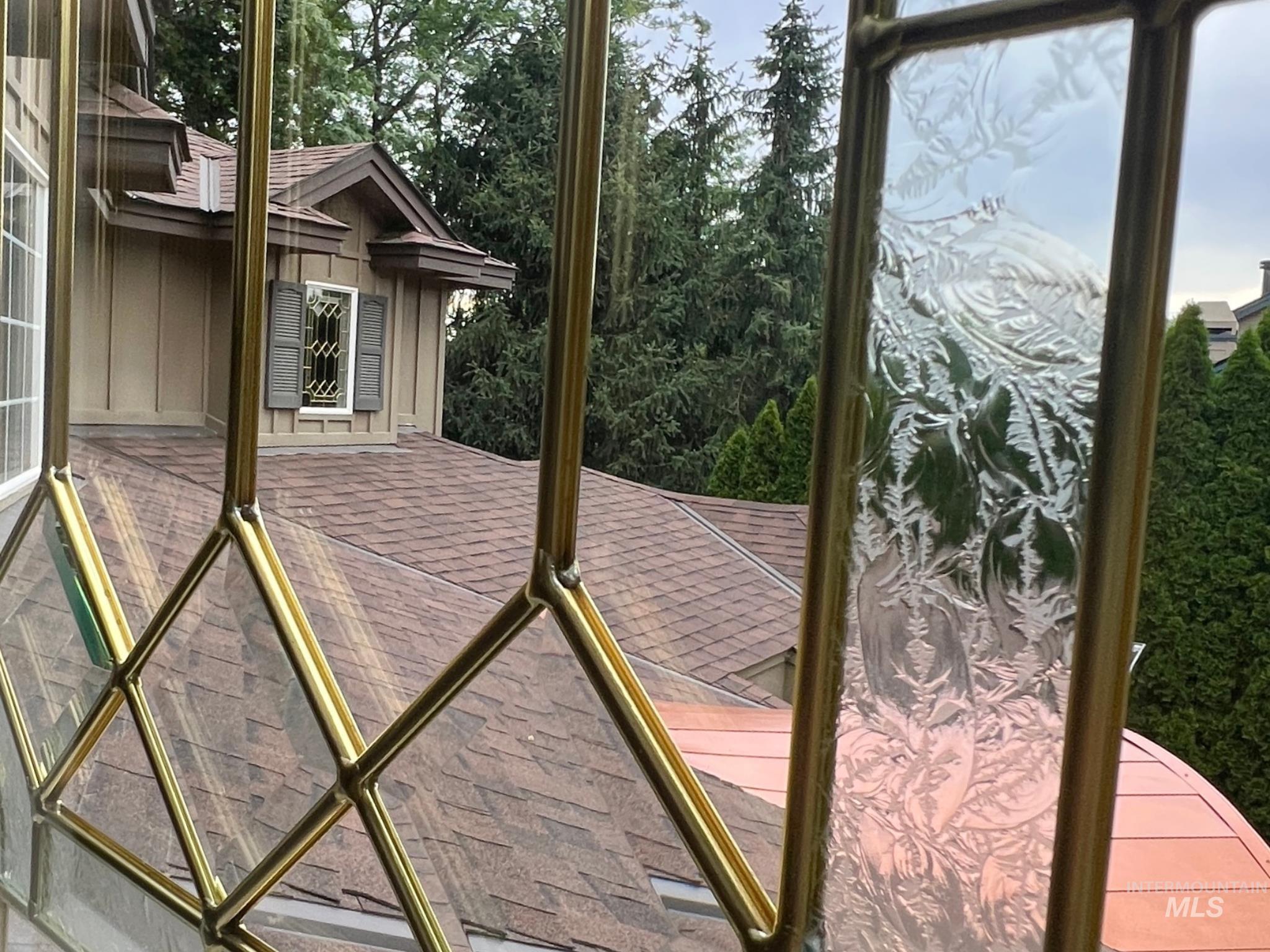 Leaded glass window featuring decorative etched panels and diamond-patterned clear glass