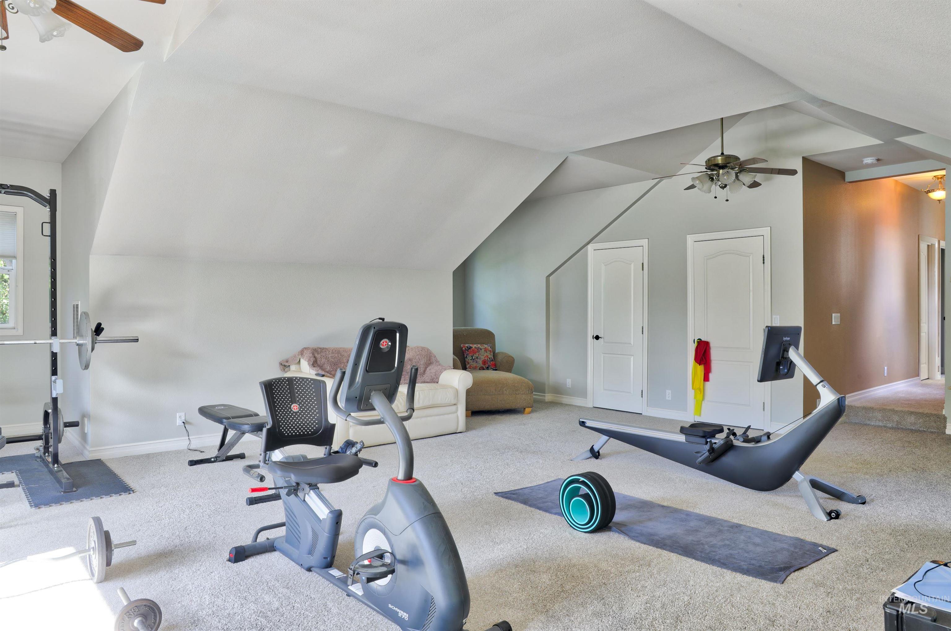 Spacious room with sloped ceilings and light gray walls