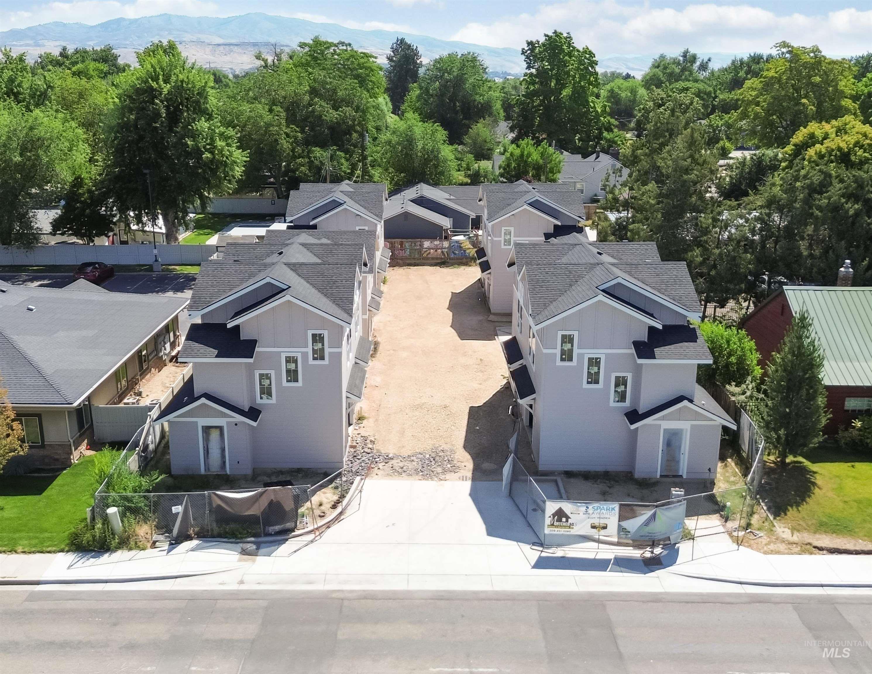 Aerial view of residential area featuring a mountainous background