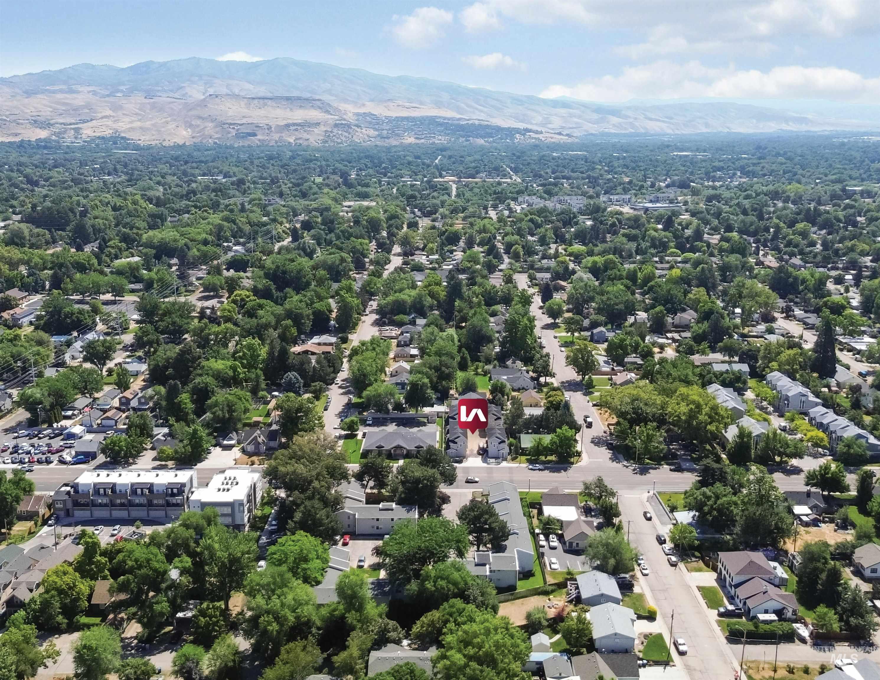 Aerial perspective of suburban area featuring a mountainous background