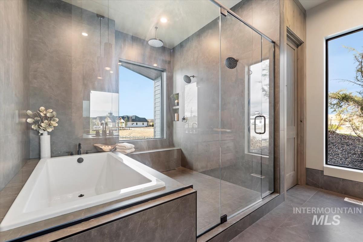 Bathroom with a bath and a shower stall