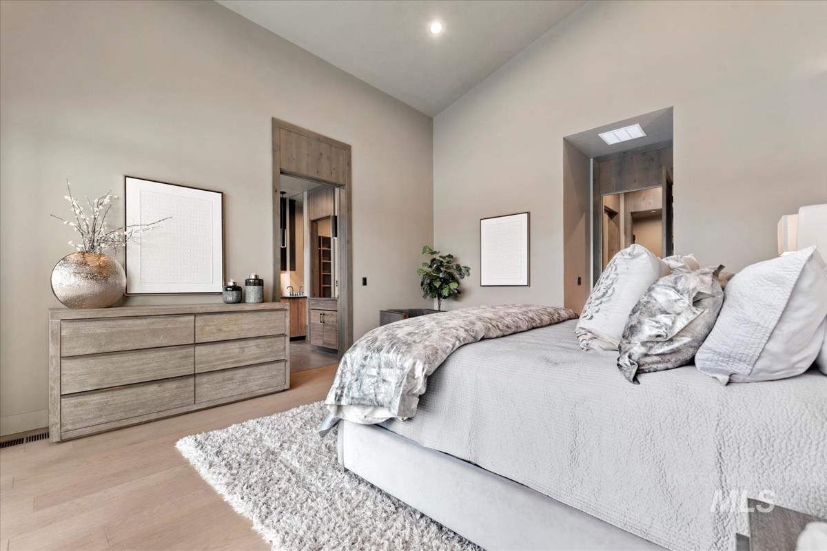 Bedroom featuring vaulted ceiling and light wood-style flooring
