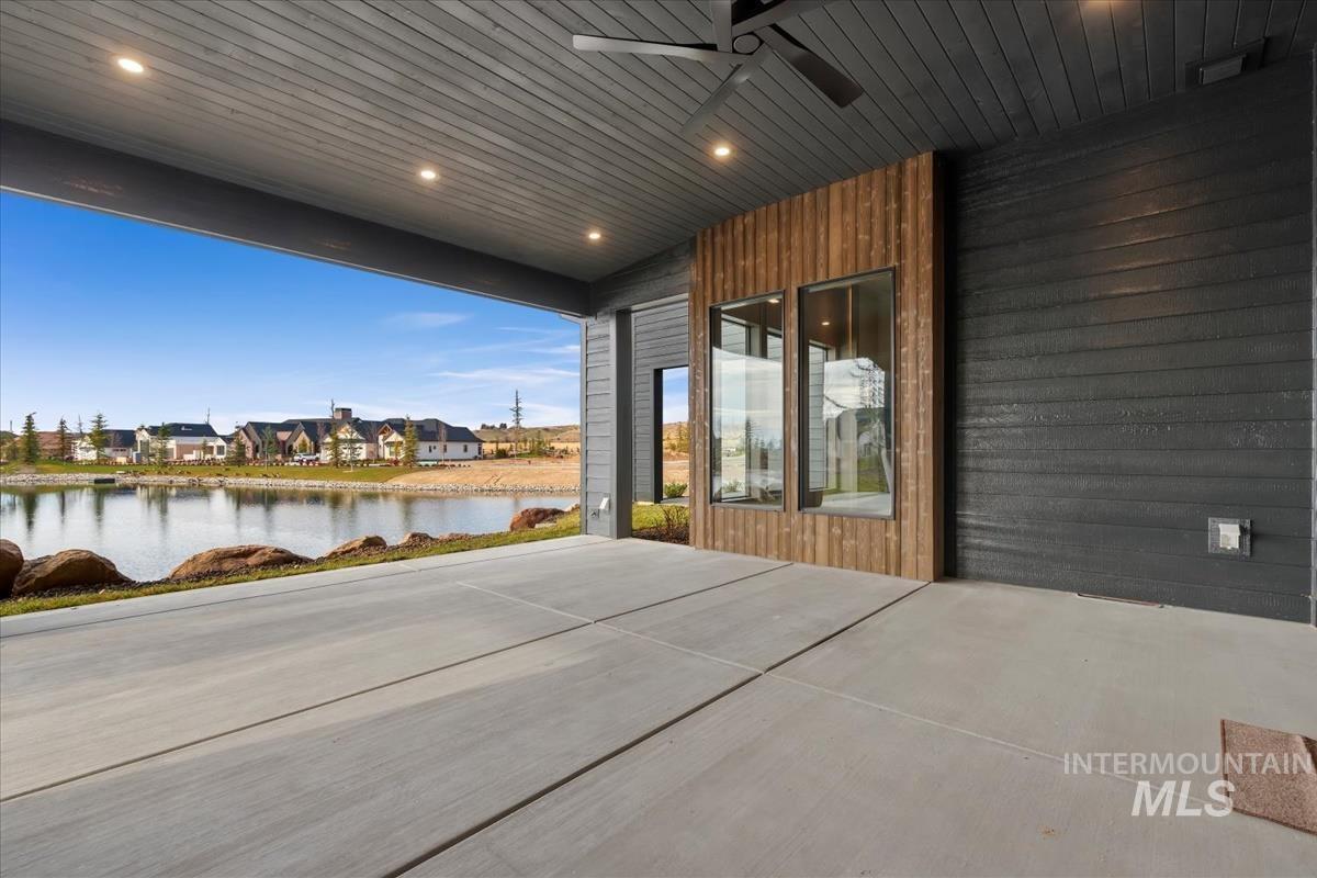 View of patio with a residential view and a water view