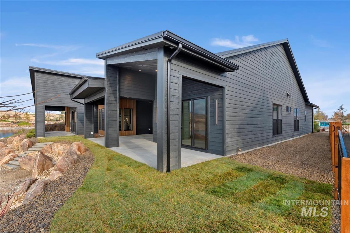 Rear view of property featuring a patio and a lawn
