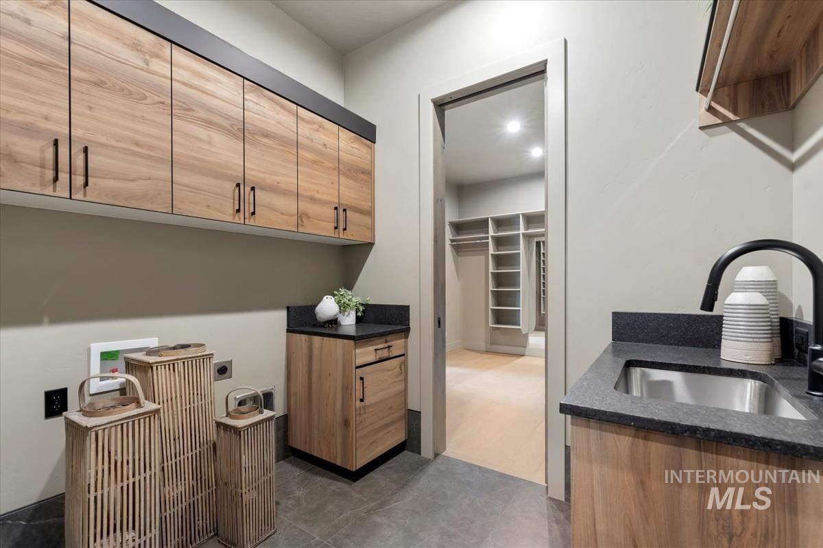 Laundry room featuring cabinet space, hookup for a washing machine, and electric dryer hookup