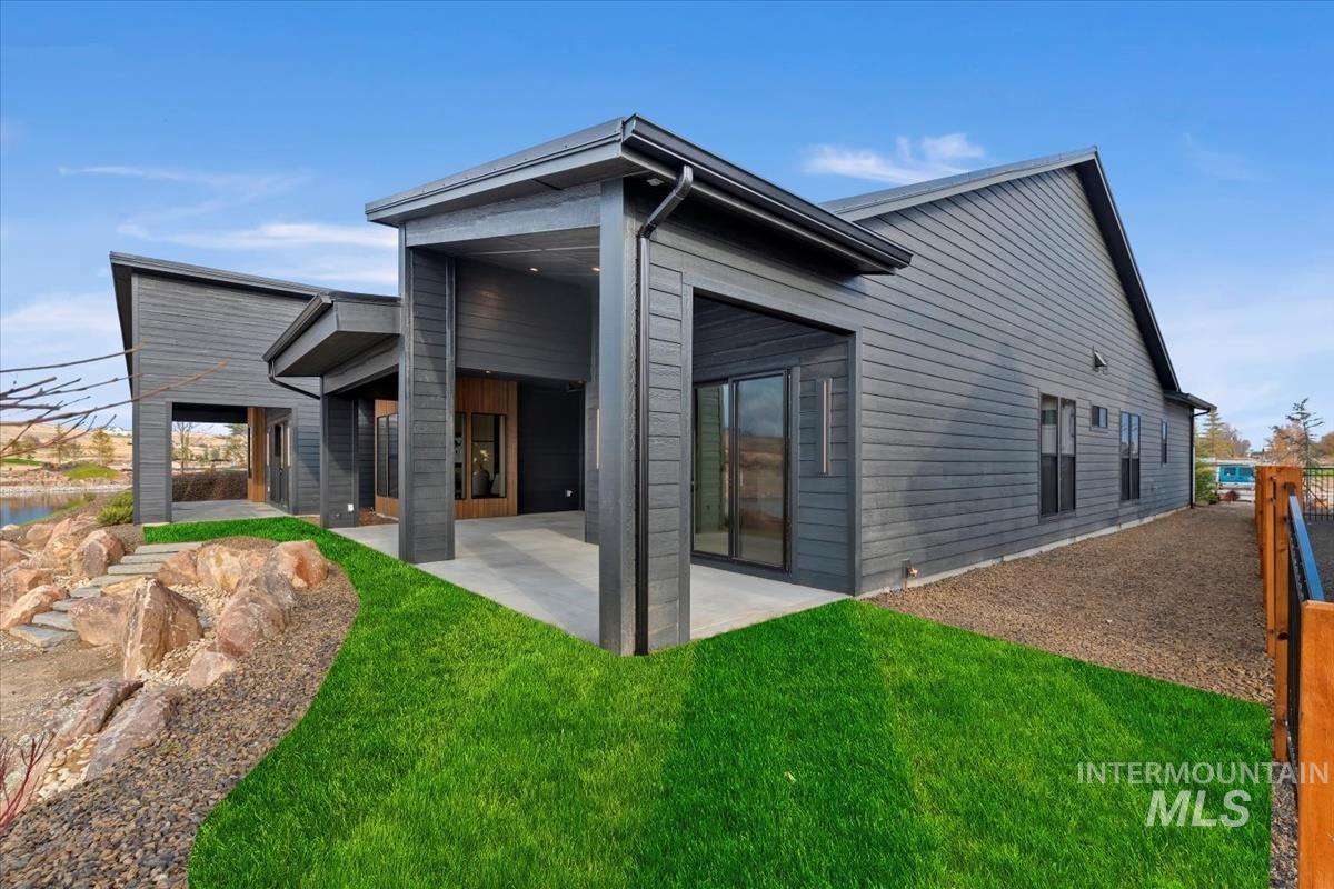 Rear view of house featuring a patio area and a yard