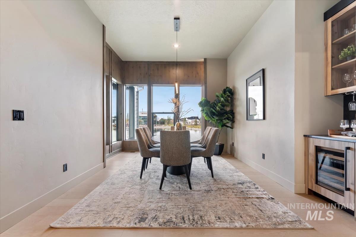 Dining area featuring beverage cooler and light wood finished floors