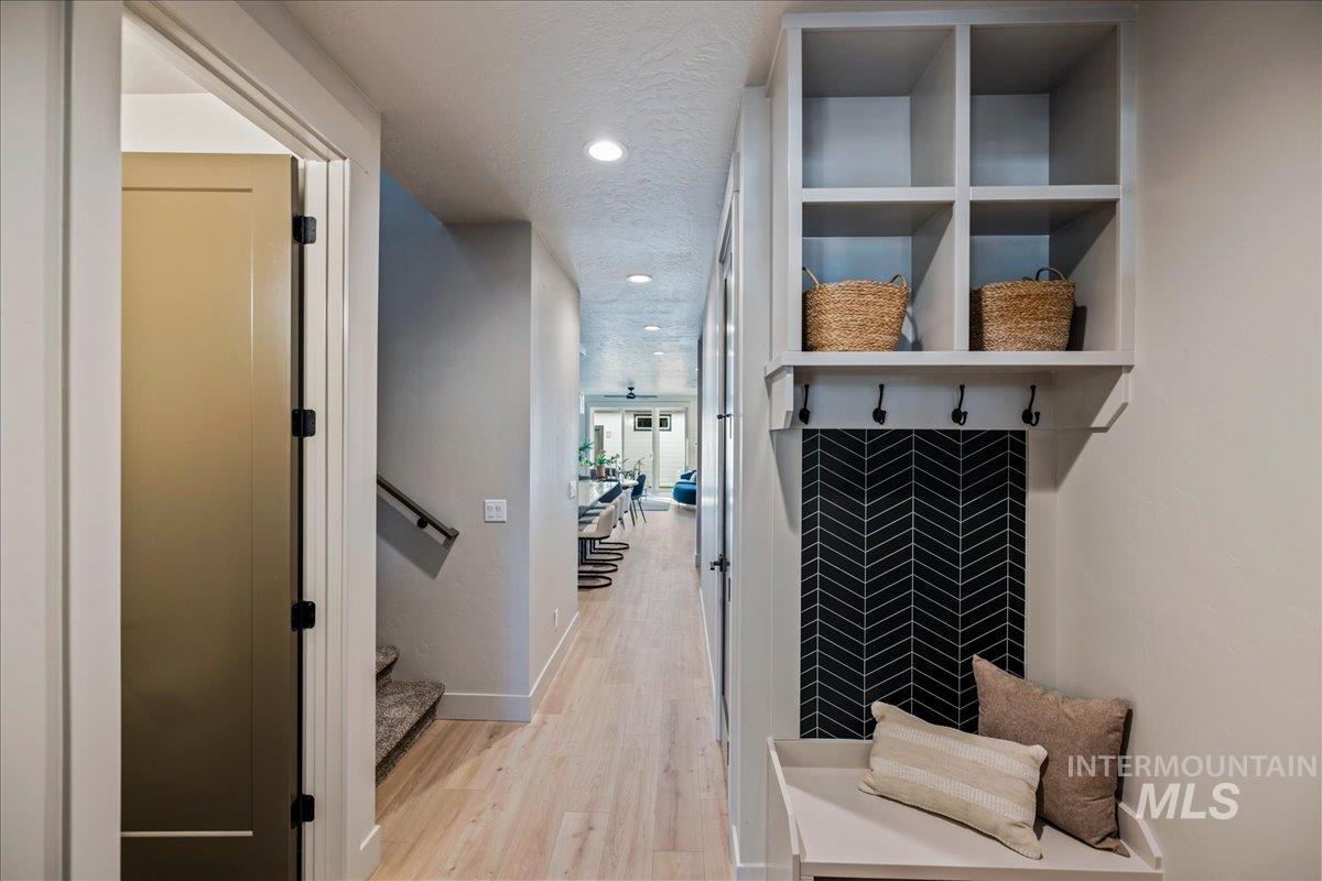 Mudroom featuring light wood-style flooring, recessed lighting, and a textured ceiling