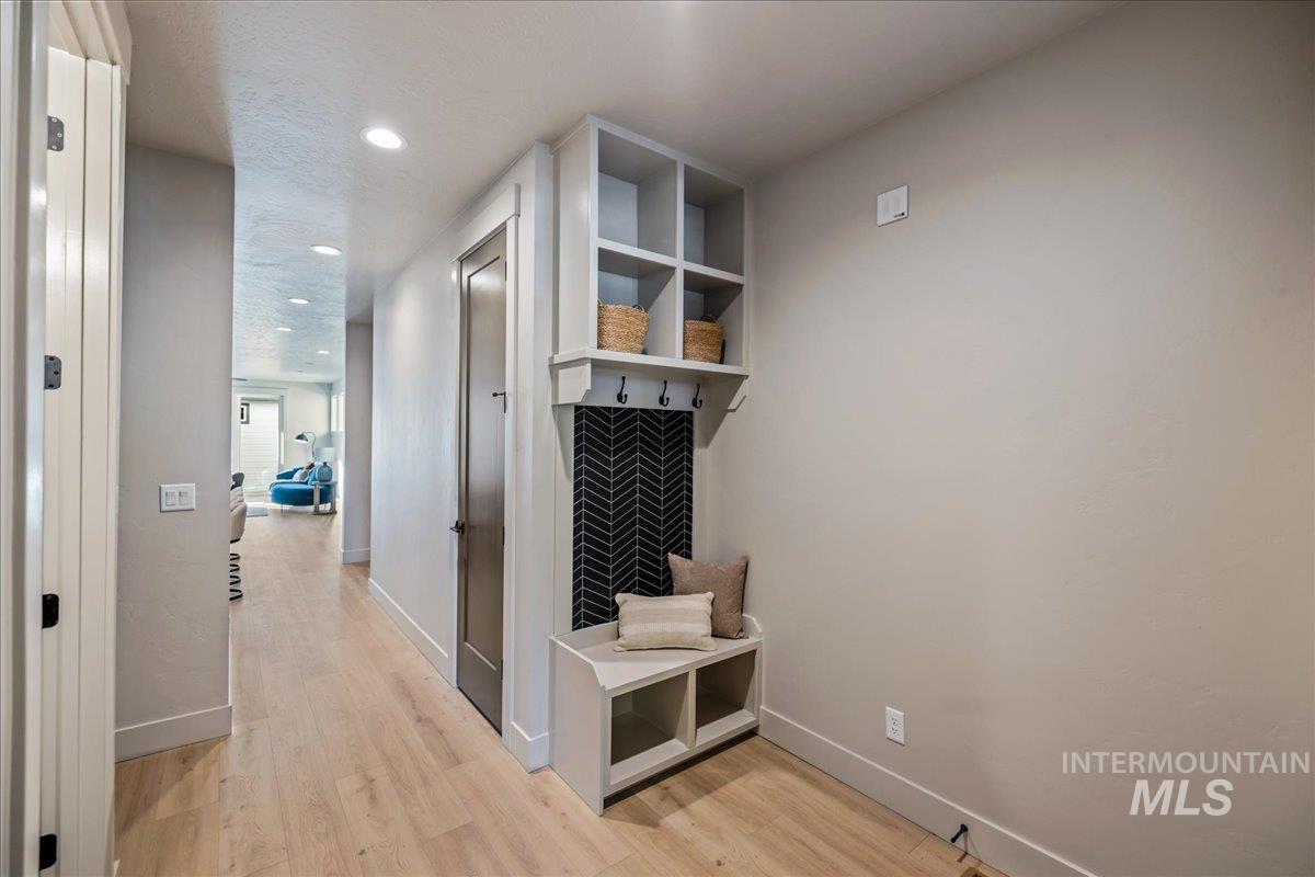 Mudroom featuring light wood-type flooring and recessed lighting