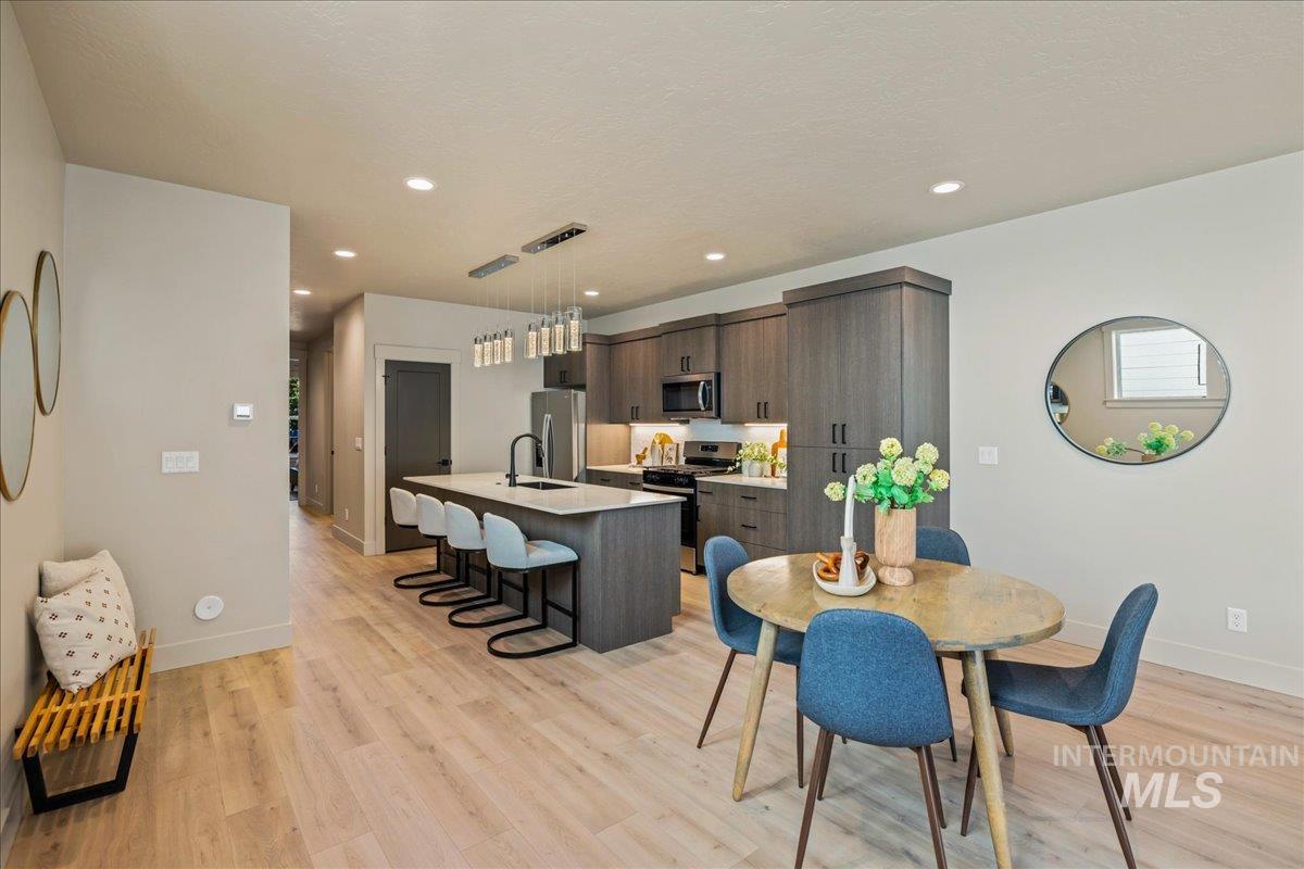Dining space featuring light wood-style flooring and recessed lighting