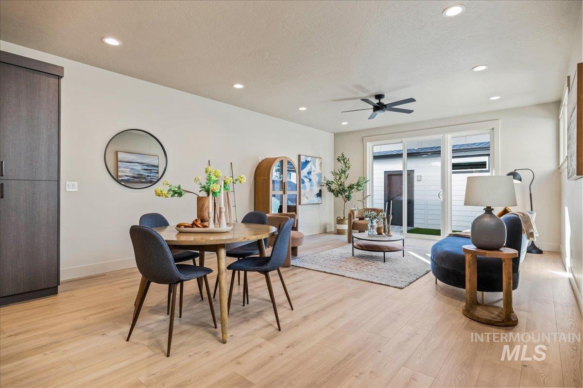 Dining space with recessed lighting, light wood-type flooring, a ceiling fan, and a textured ceiling