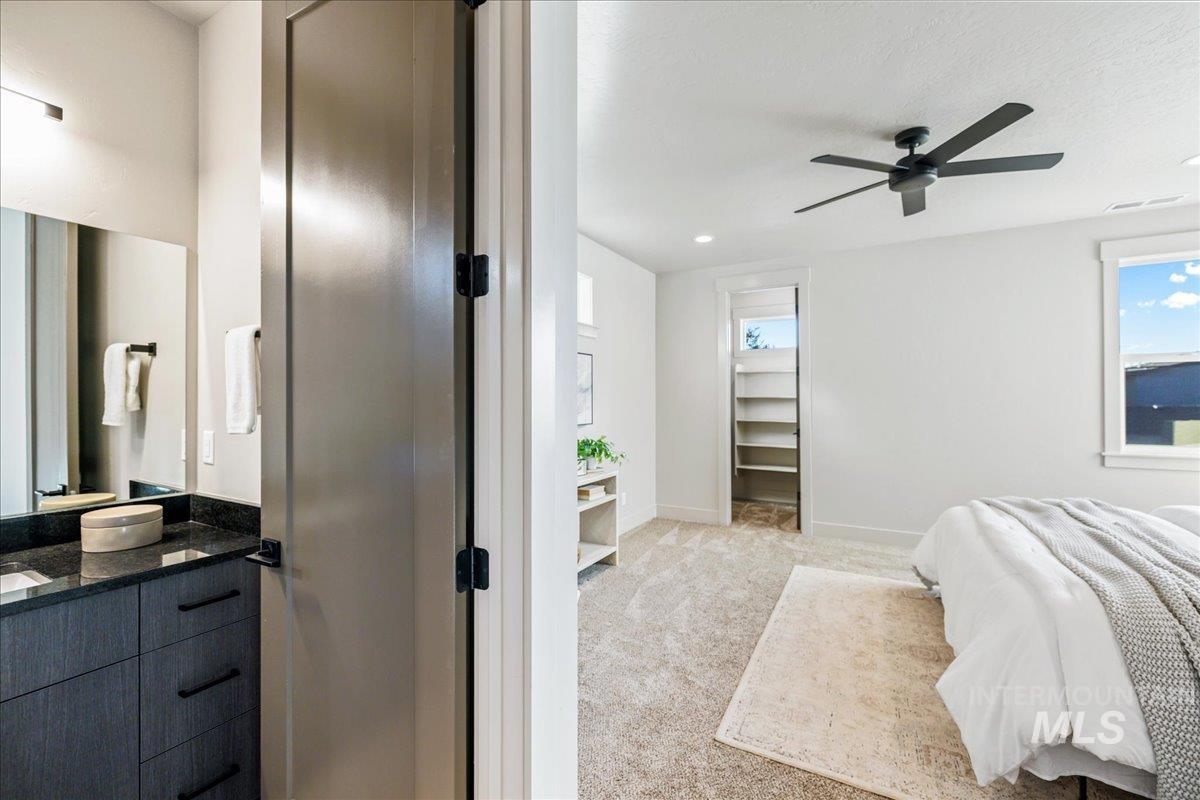 Bedroom featuring light carpet, a ceiling fan, and recessed lighting