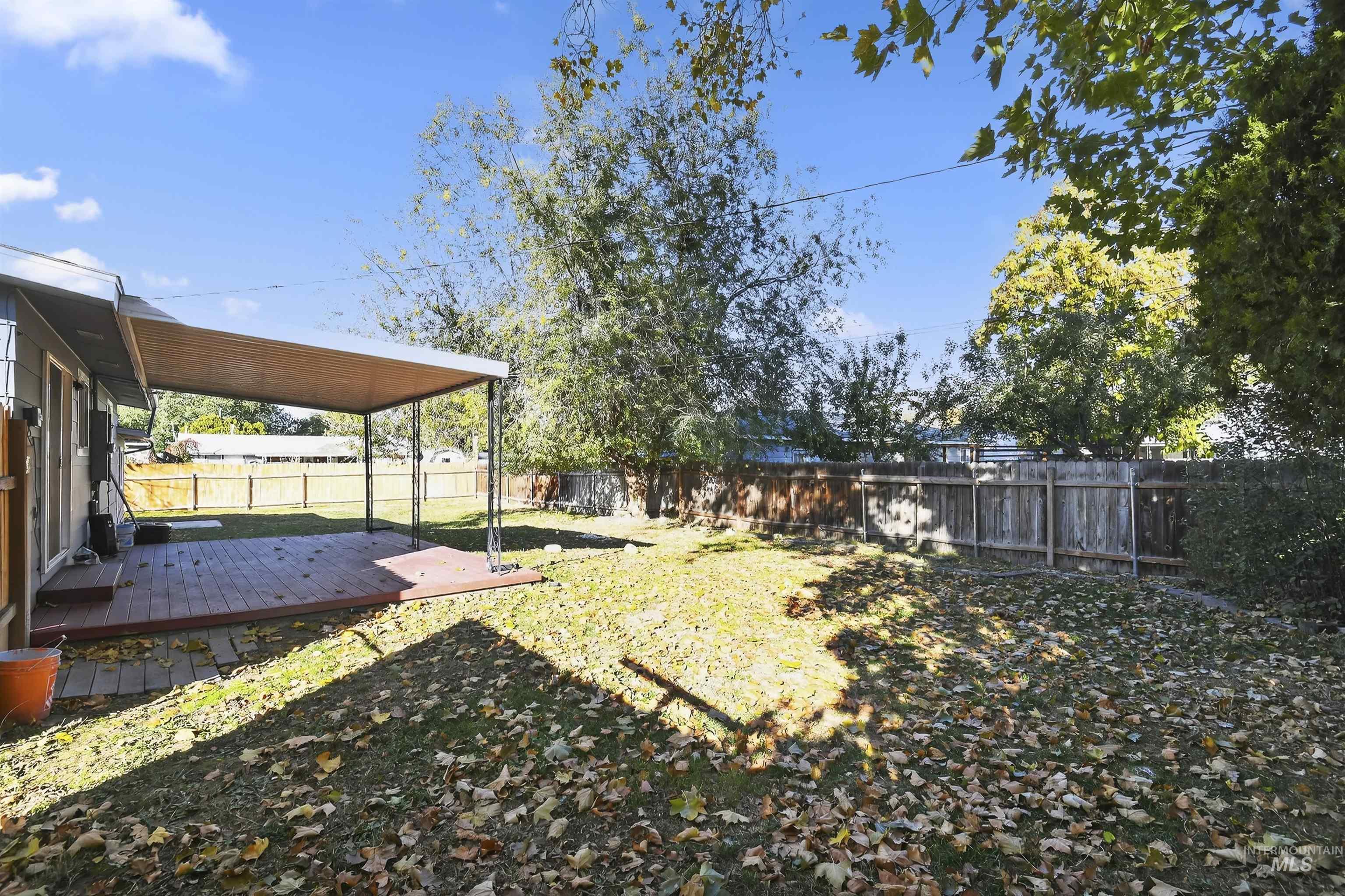 Fenced backyard featuring a wooden deck