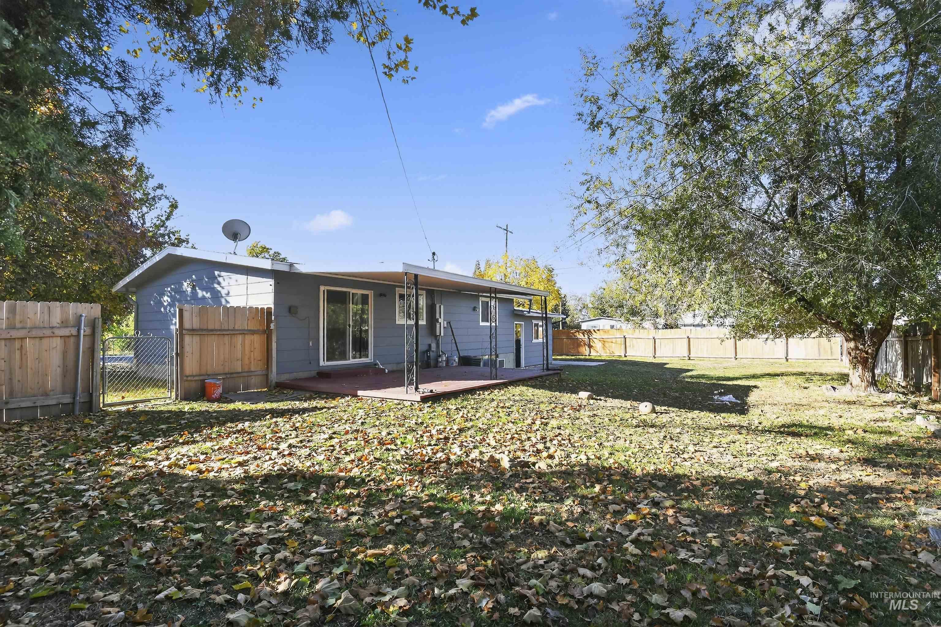 Rear view of property with a fenced backyard and a patio area