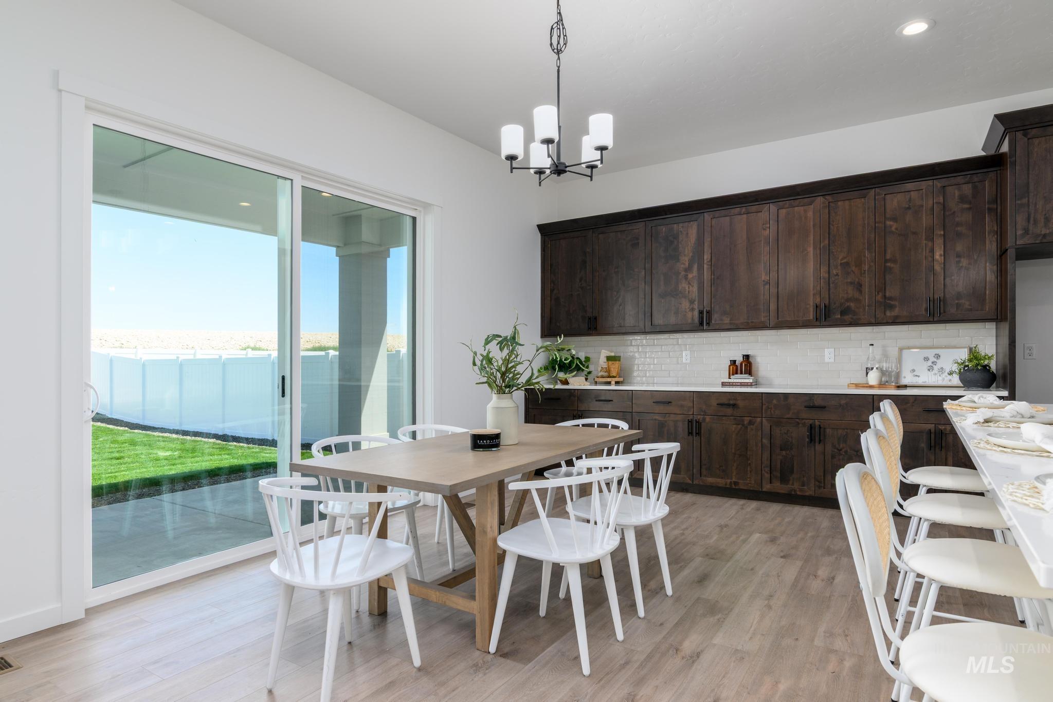 Dining space featuring light wood-style floors, a chandelier, and recessed lighting